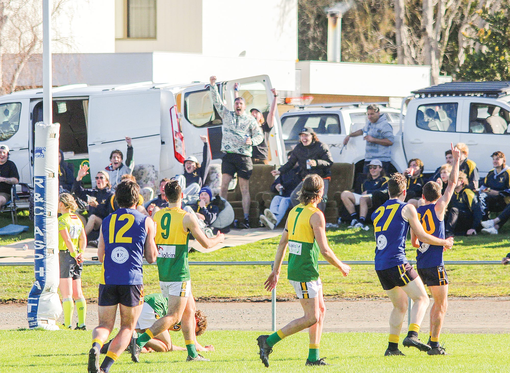 Lachlan Johnson and the ‘ressie hill’ celebrate a goal.  B03_3122