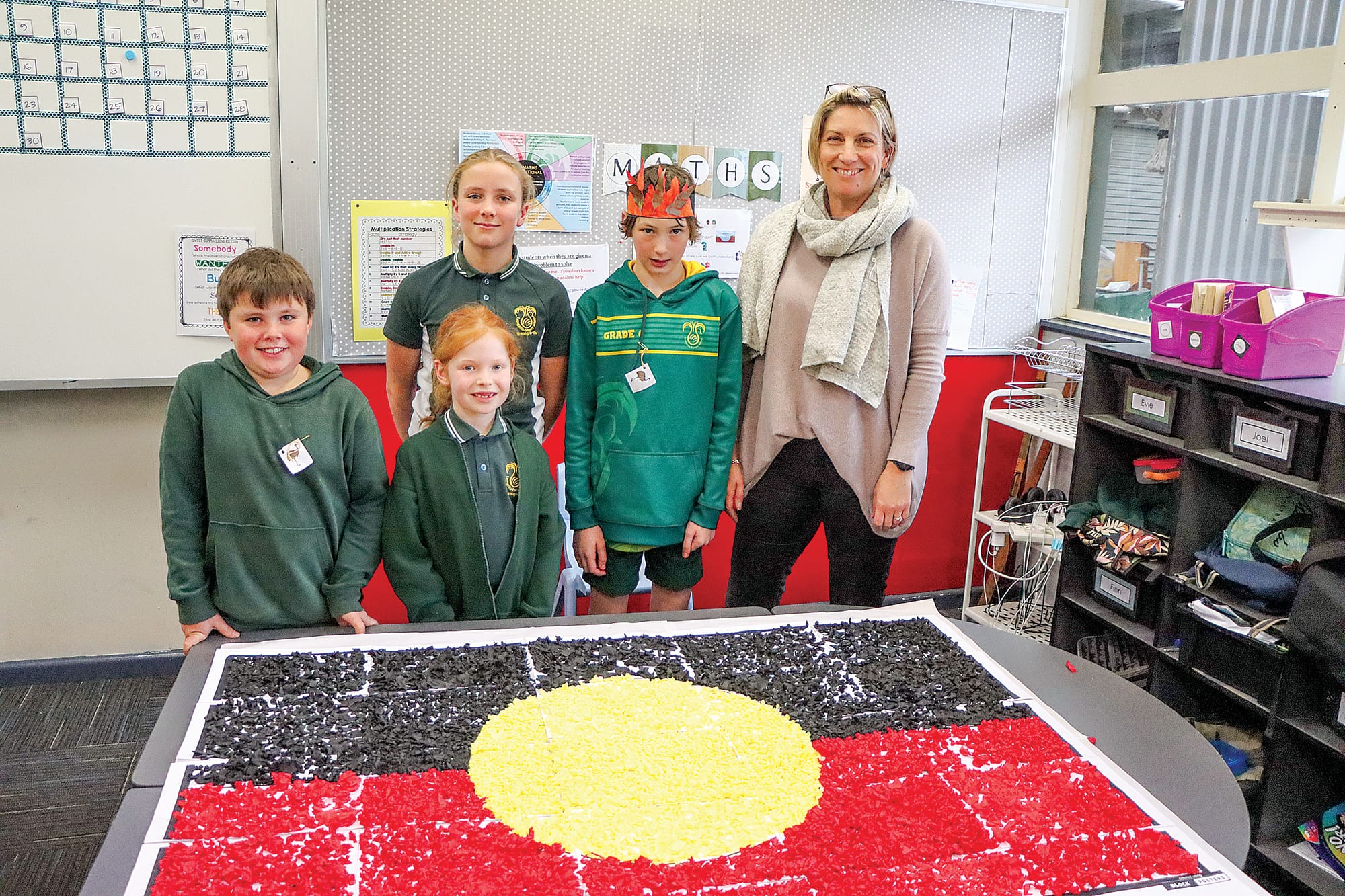 Joel, Arya, Mae, Levi, and grade 3 teacher Melanie Hughes enjoy the completion of one of the NAIDOC Week activities. A11_3024