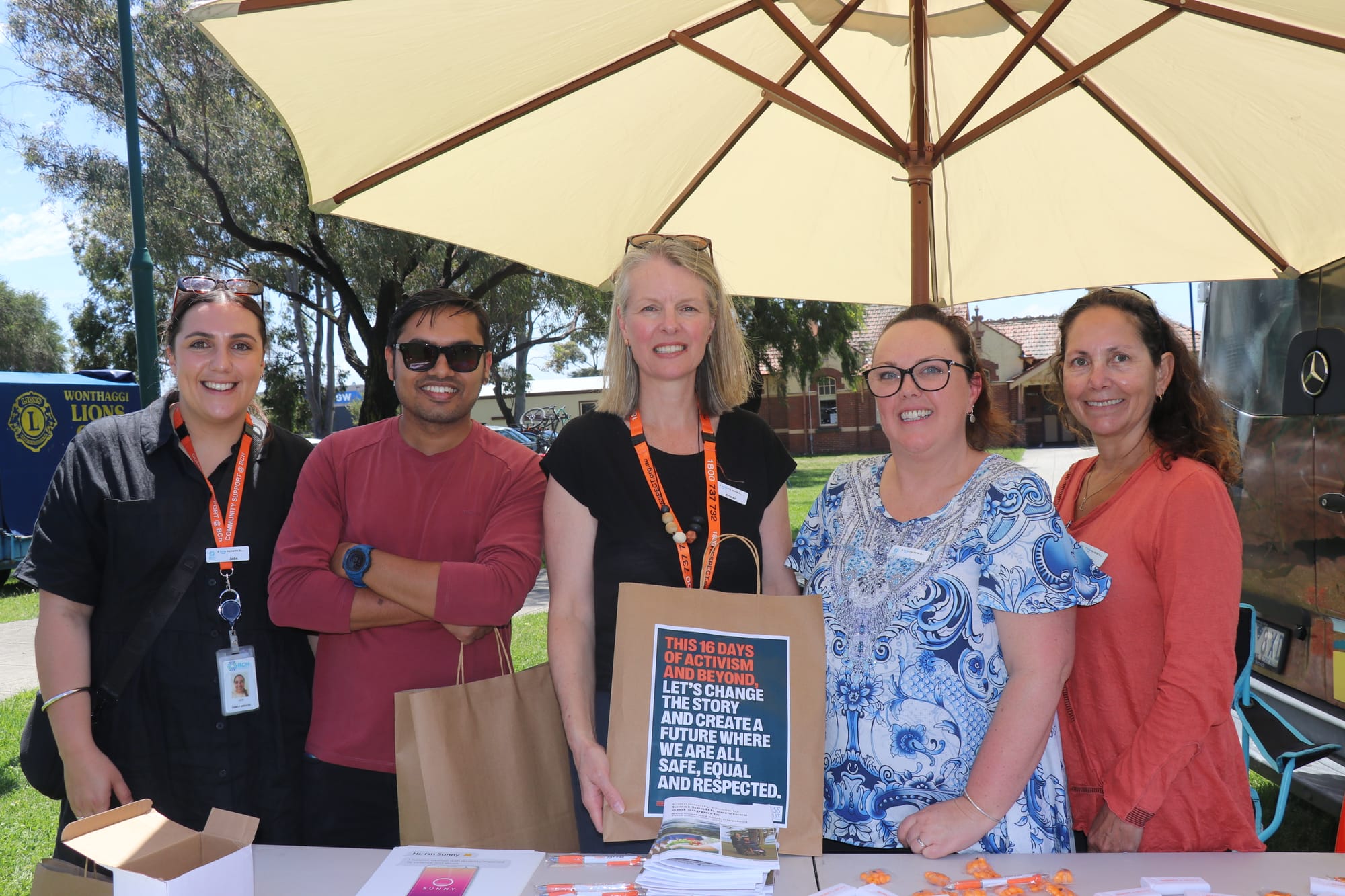 Bass Coast Health team Jade Ray-Angarane, Pradeep Giri, Kristen Yates-Matthews, Cara Hammond, and Linda Trevisi at the Big Respect Pop-Up stand raising awareness against gender-based violence. 