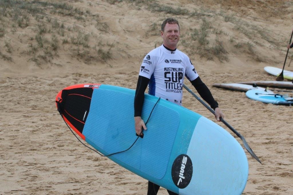 Sam Hodder of Dromana heads down the beach at Cape Woolamai ready for the start of his Australian SUP Titles heat on Thursday.