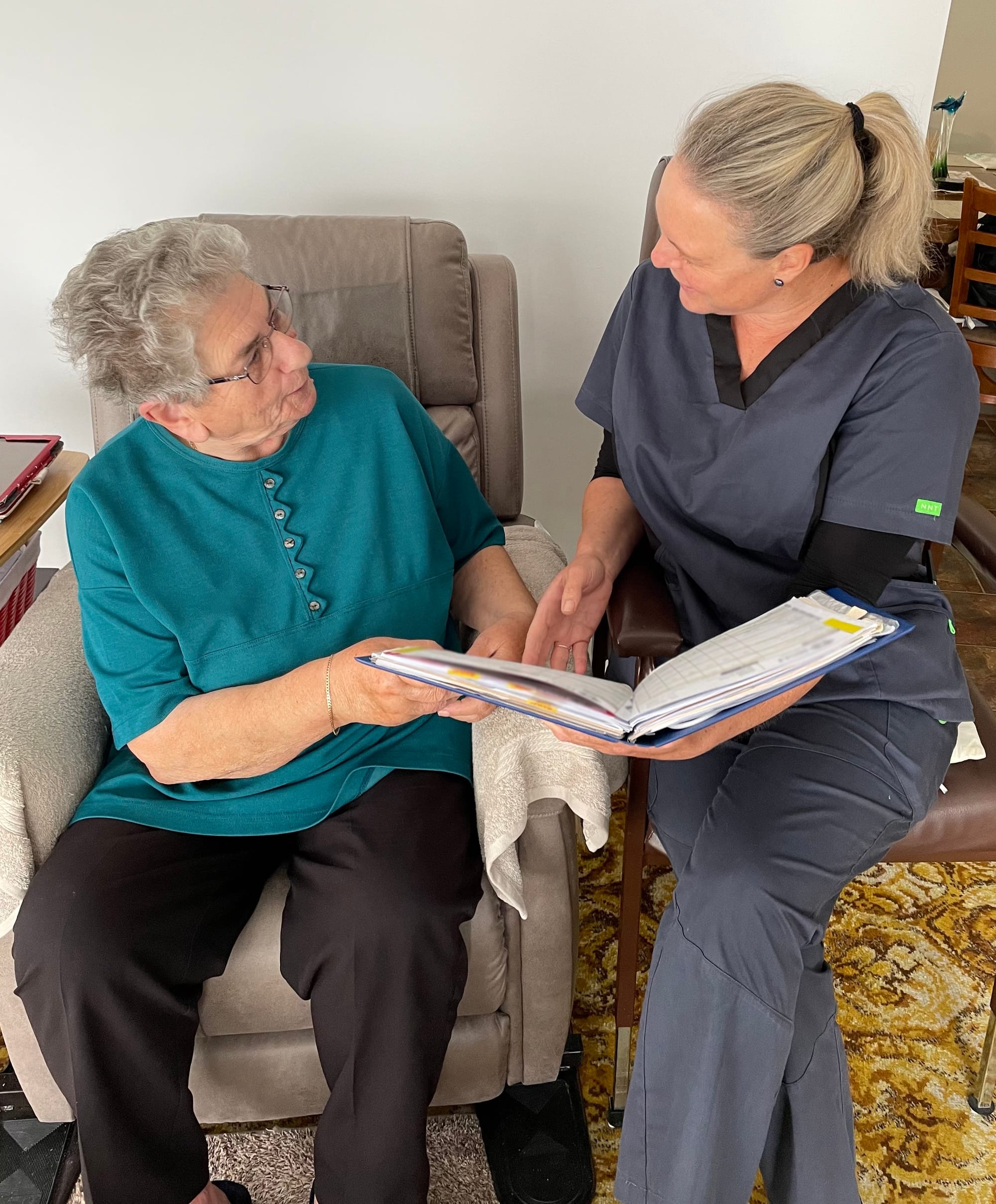 District Nurse Carrie Eastwood reviews a care plan with client Bertilla Pupetti.