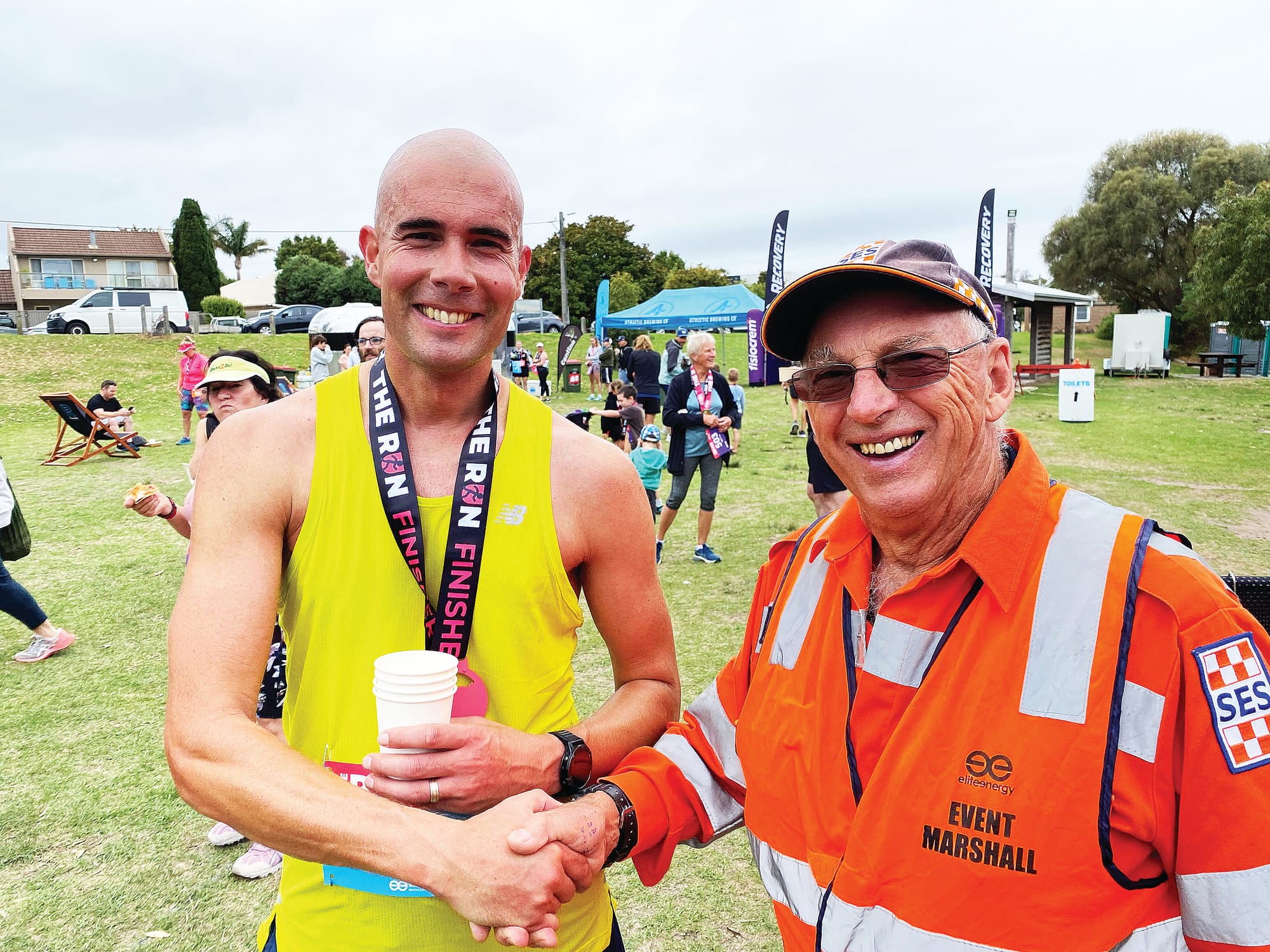 Adam Bellairs of Inverloch is congratulated on crossing the line first in the Bass Coast ‘Run the Coast’ marathon on Sunday by SES member Neil Warren, Adam completing the run in a time of 3.13.