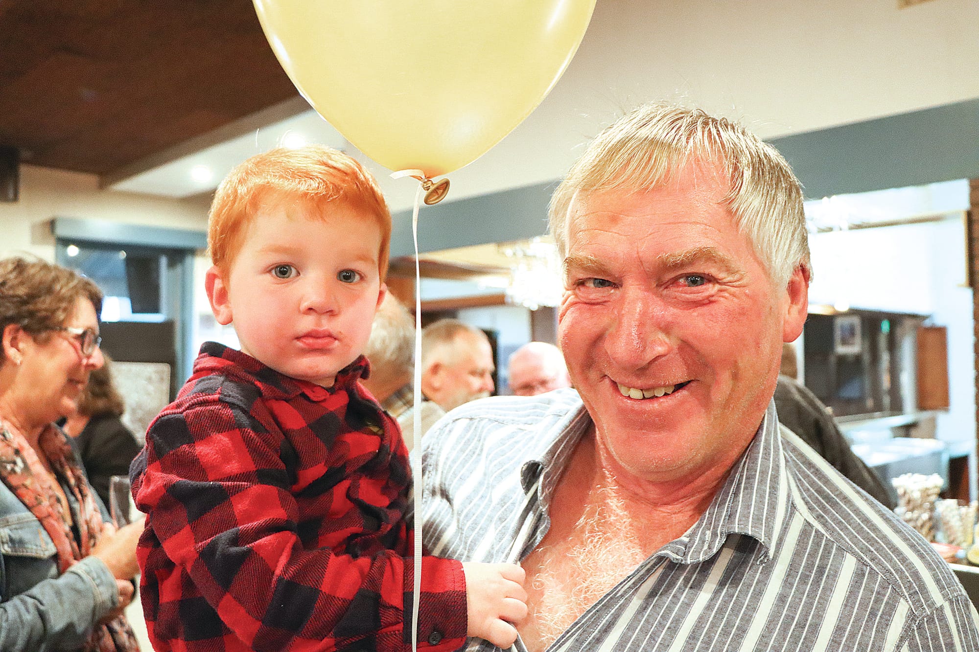 Logan and Ian Conn enjoy the event honouring Eddie and Helen Fowler for their 50 years in business, with Ian a long term customer. A31_2124