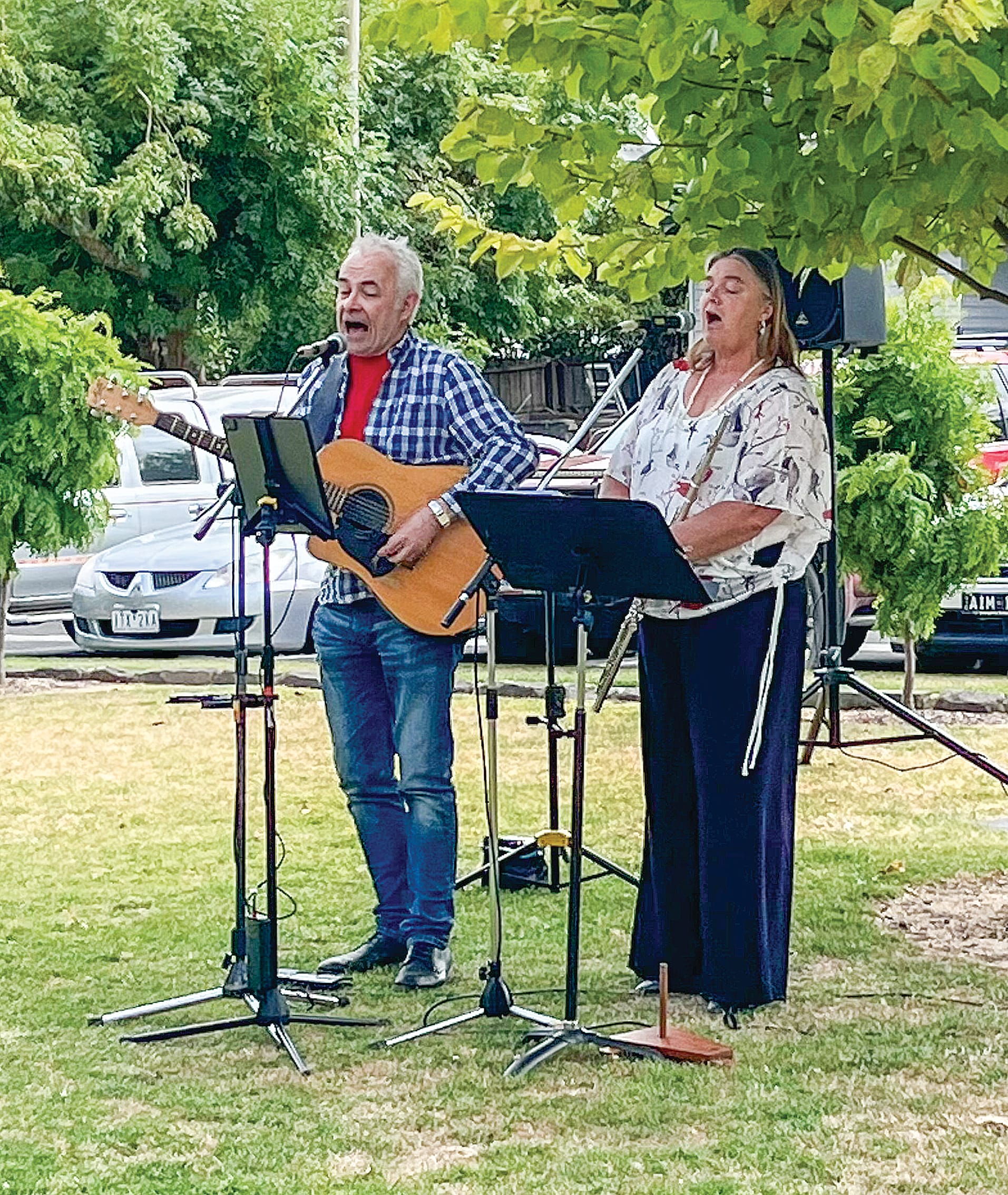 Terry Lay and Christine Ross singing the National Anthem at the Korumburra Australia Day event in Coleman Park. 