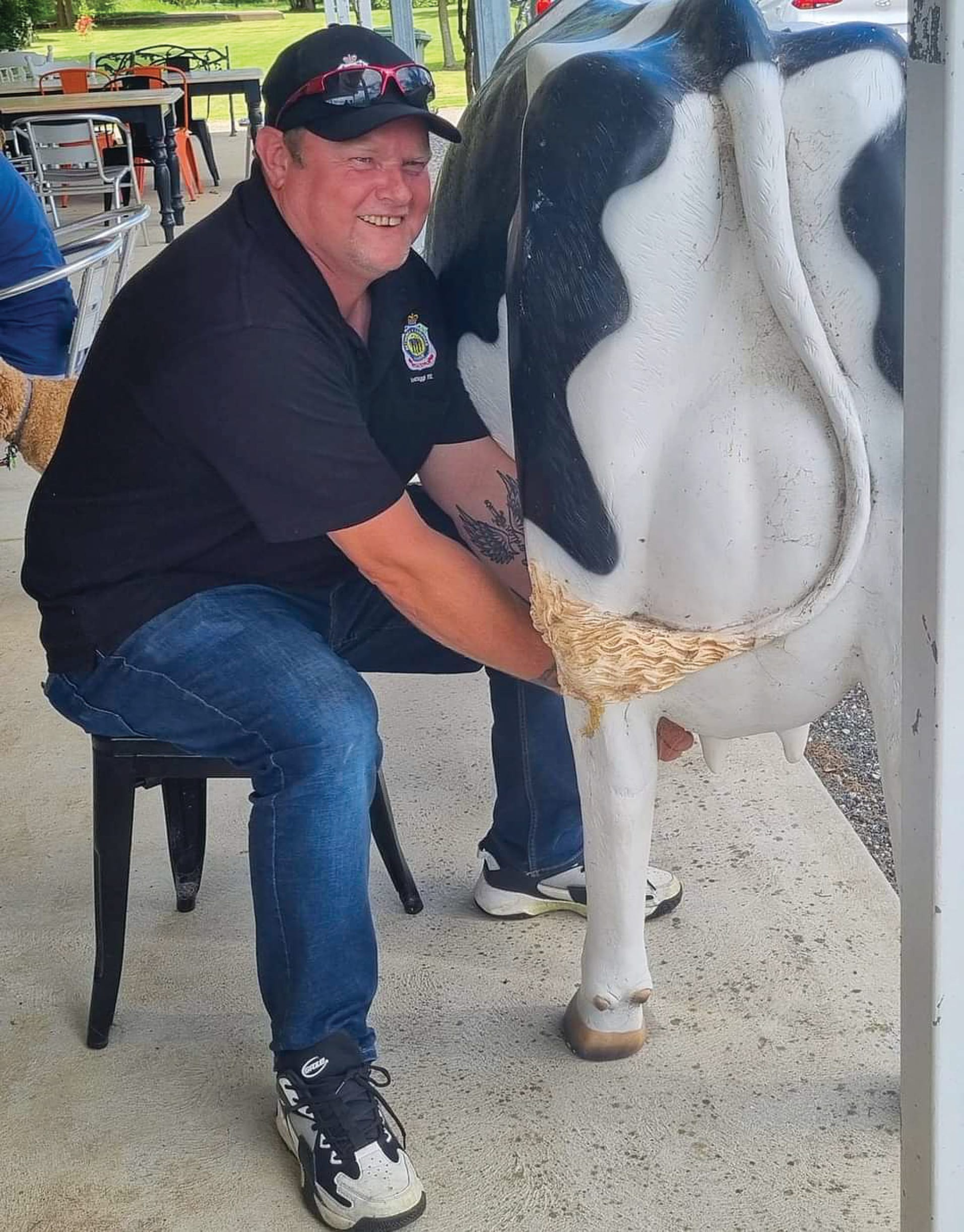 President of Wonthaggi RSL Dan Lucas practicing milking at Bassine Cheeses.