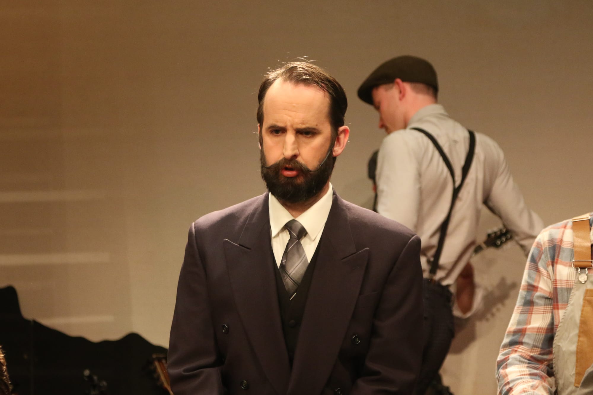 Usually under the stage, Nick Carver (Mayor Josiah Dobbs) tests the microphone. 