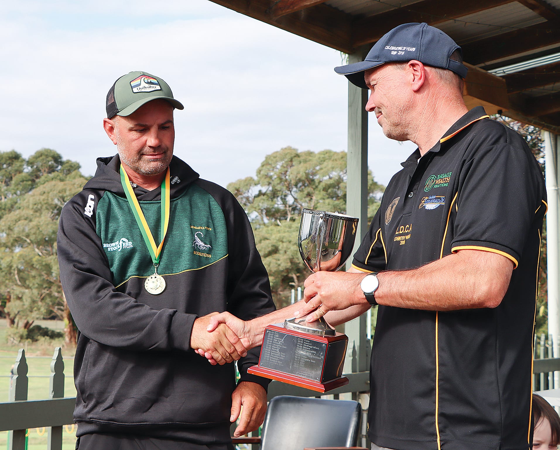 Winning skipper Mark Hardy receives congratulations and Leongatha Town’s B2 premiership cup from the LDCA’s Gary Sauvarin.