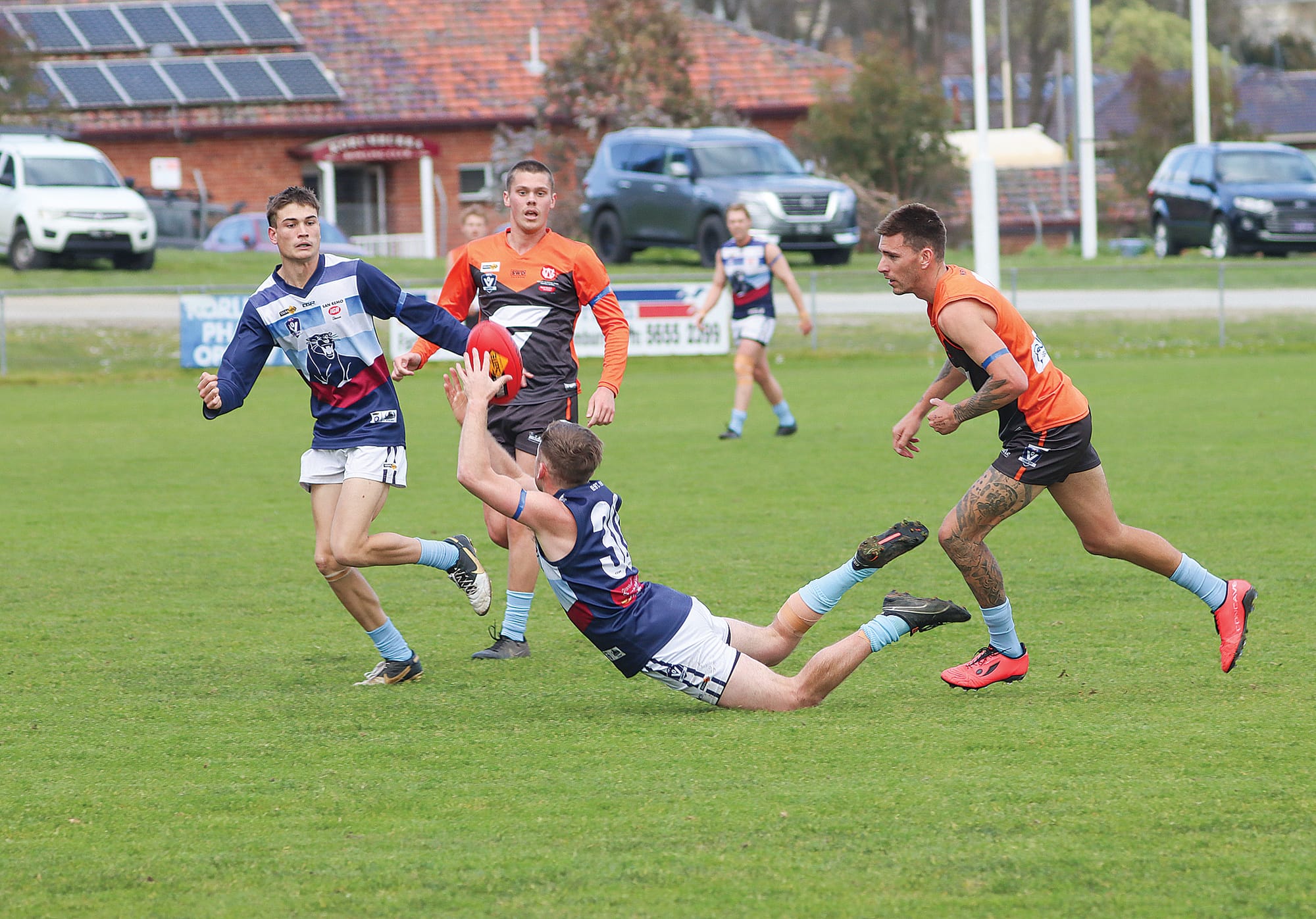 Jonathon Rocotas dives for the mark for Kilcunda-Bass as Korumburra-Bena coach Josh Hopkins closes in, the footy spilling free. A19_3324