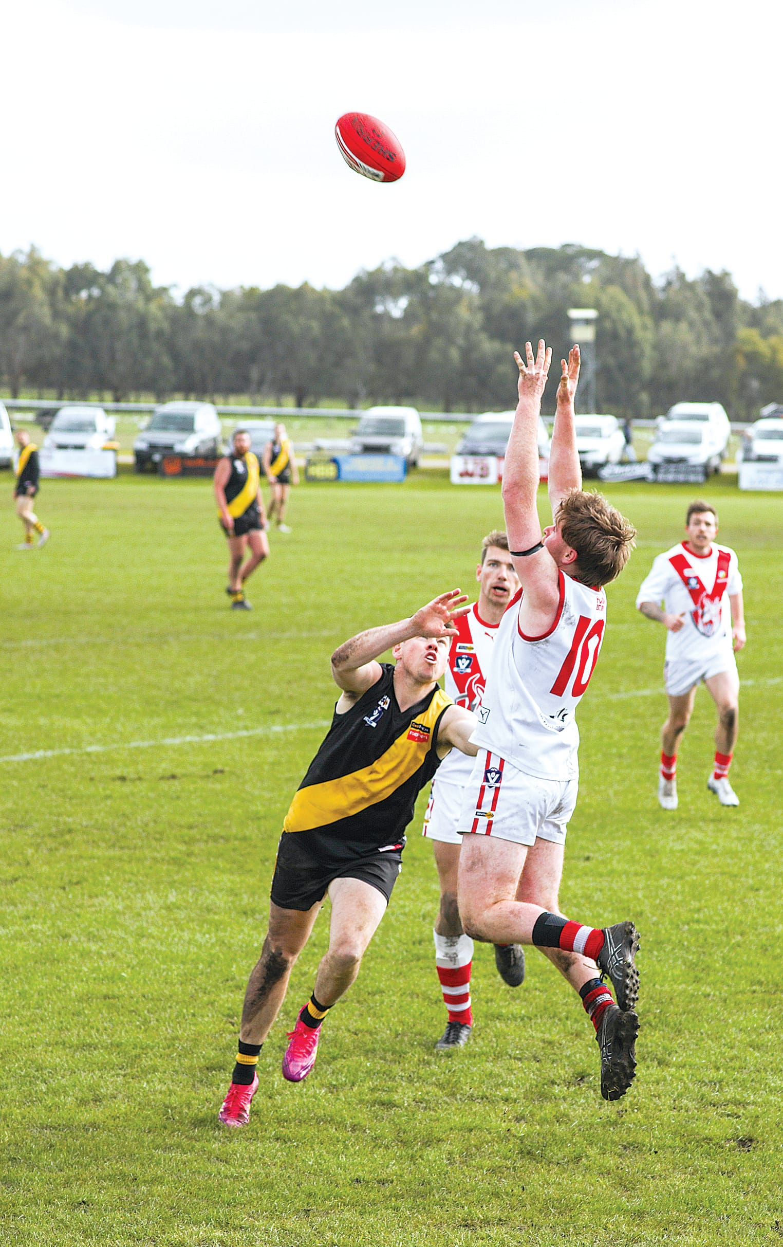 Fish Creek’s Kairon Dorling flies for the footy, but his Foster opponent did enough to prevent the mark. A06_3525