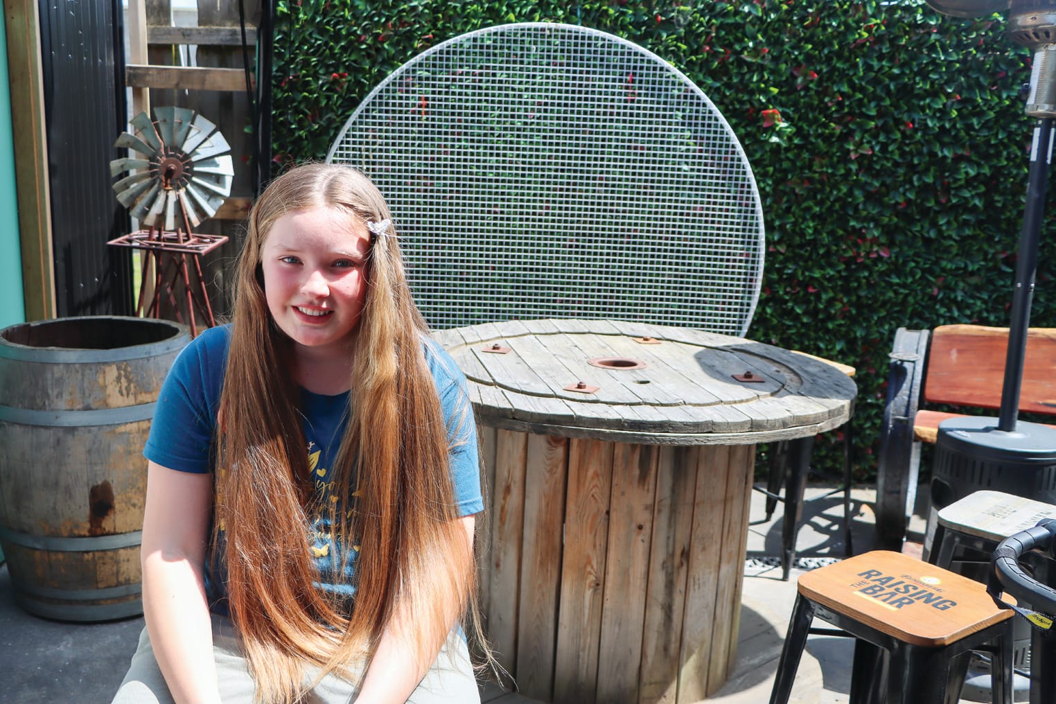 Tayla’s long hair glistens in the sun shortly before getting a substantial cut for a cause. A38_4523