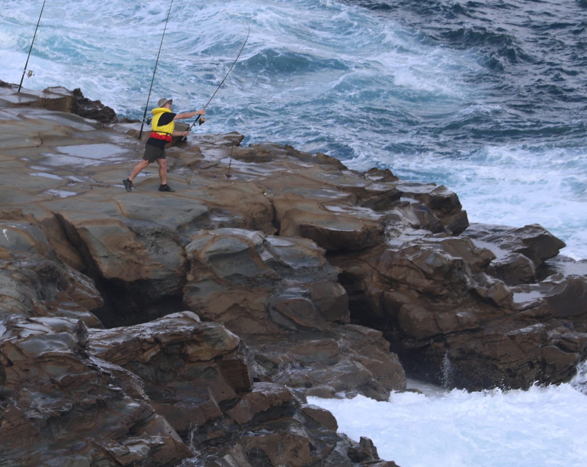 This rock fisherman takes his life in his hands as he casts out from the treacherous Punch Bowl Rocks on Easter Monday despite the tragedy there on Good Friday.