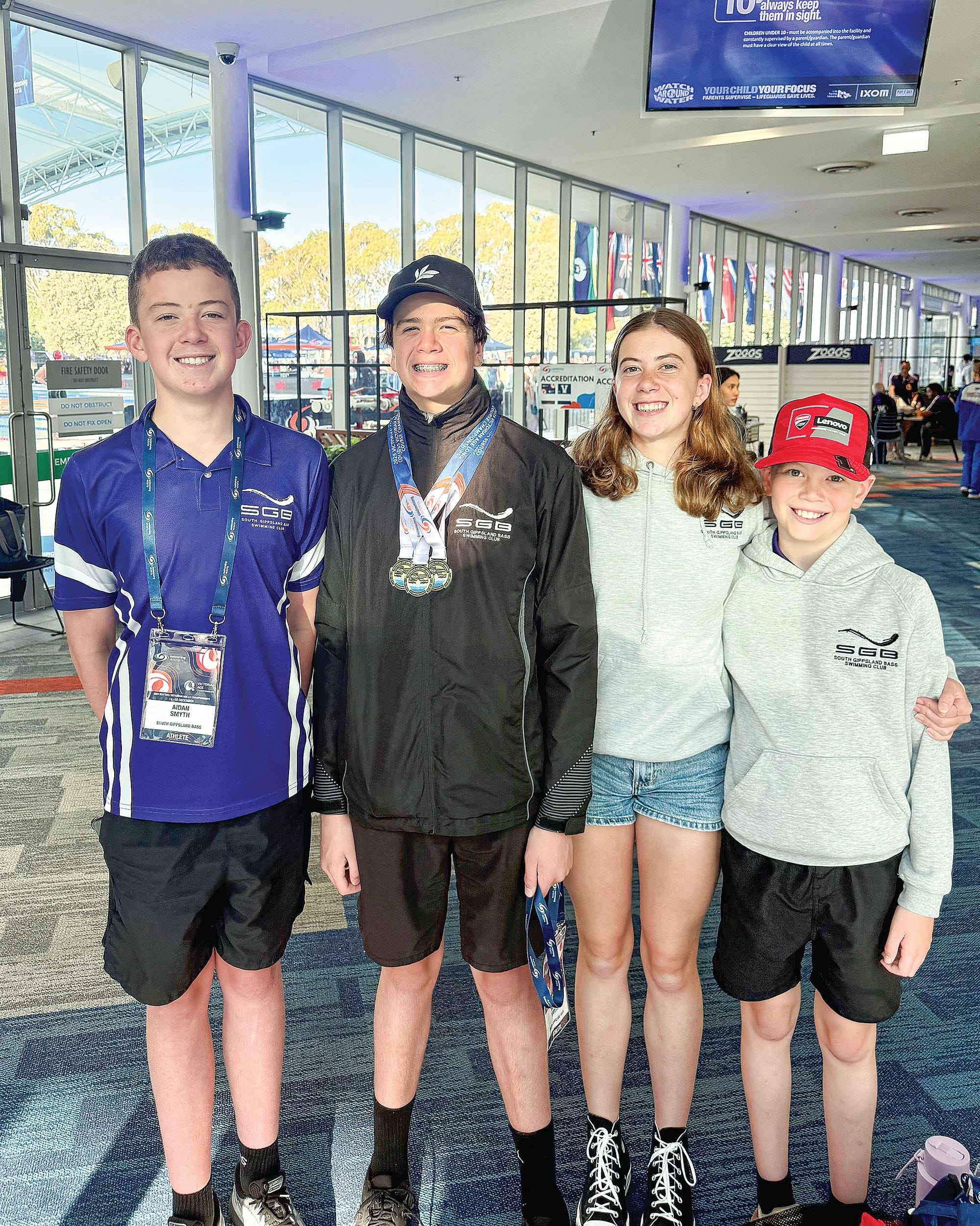 Archie celebrates with his family, Aidan and Lara who swam and Darby who cheered loudly for them. 
