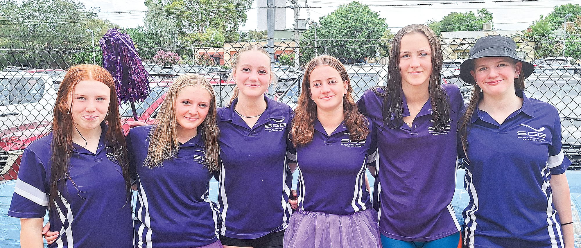The girls compare their medal winning relay swims.