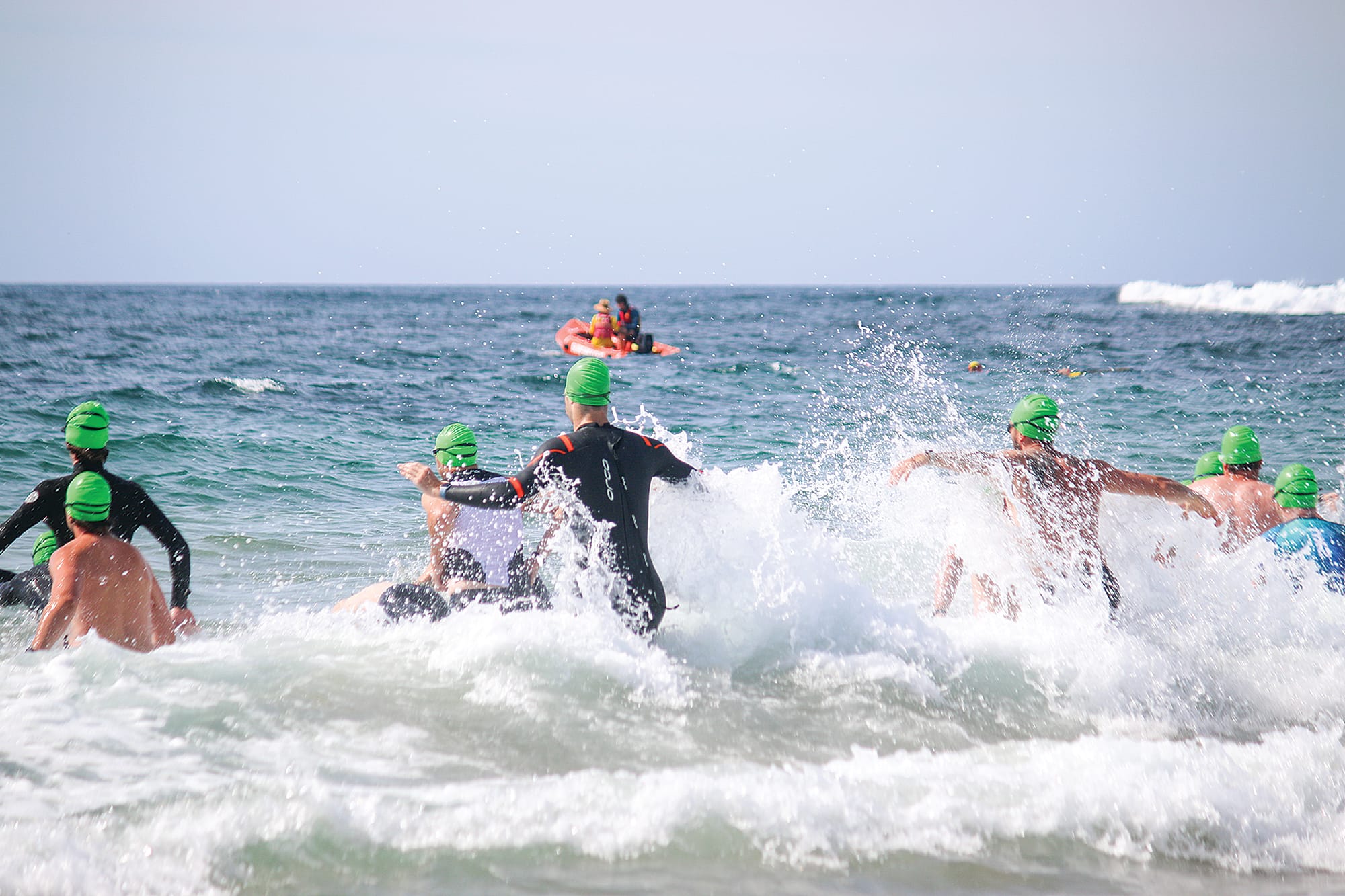 Green caps hit the water for the swim leg of the aquathon. ob38_0325