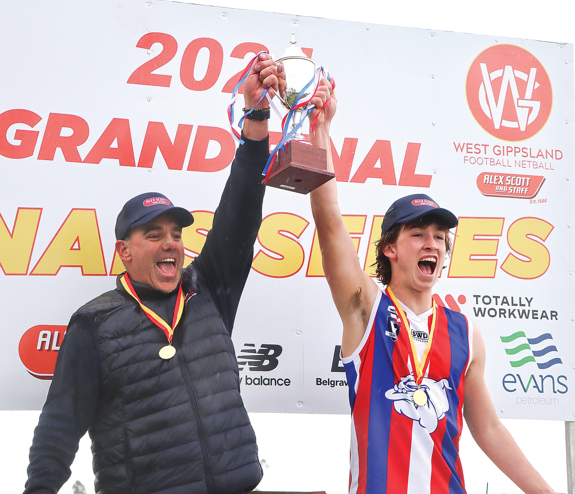 Coach Scott Huther and captain Leo Savona of Phillip Island raise the Under 18s premiership cup. A34_3824