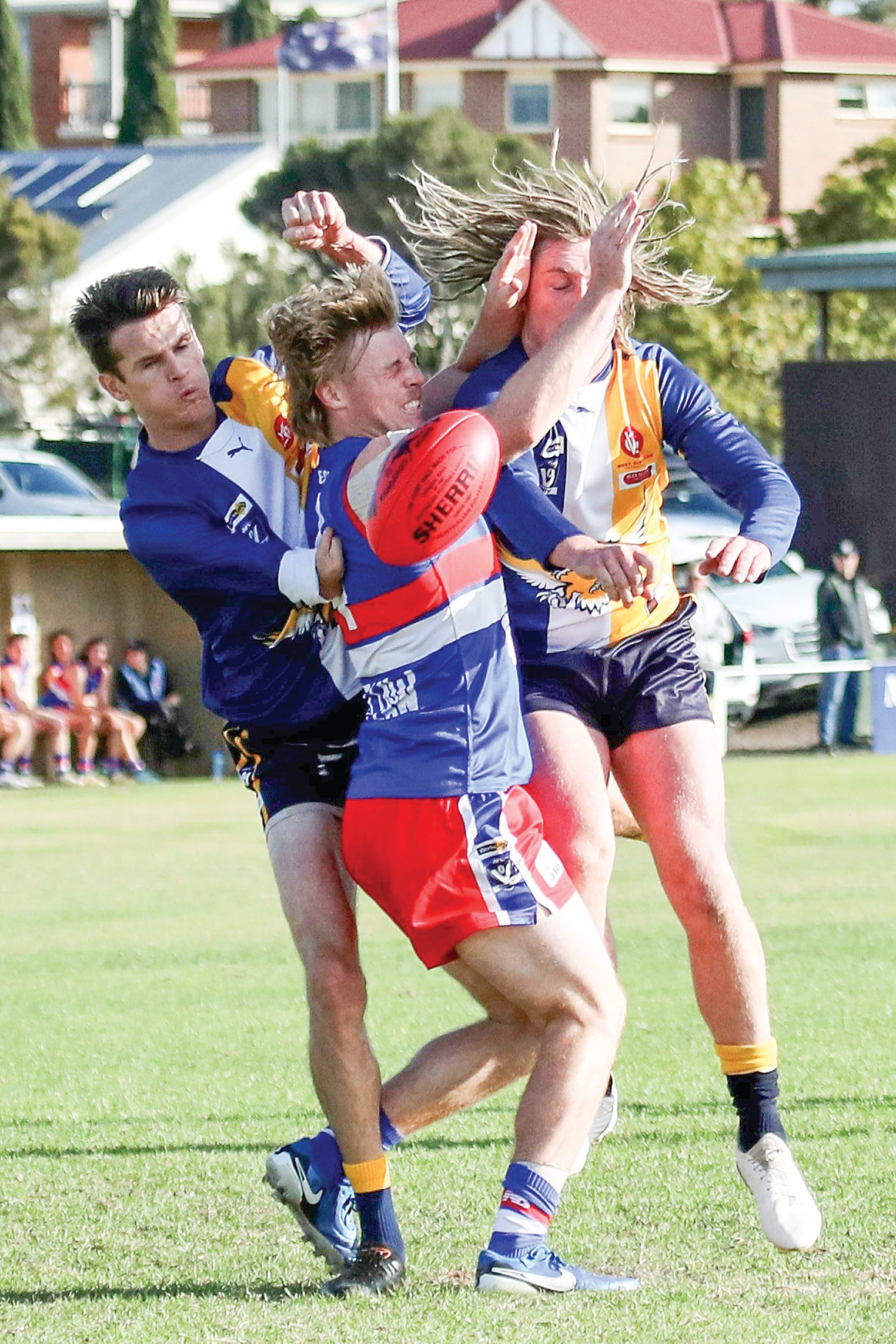 Phillip Island’s Charlie Bruce is sandwiched between a couple of Inverloch-Kongwak opponents, the Bulldogs in charge throughout the day.