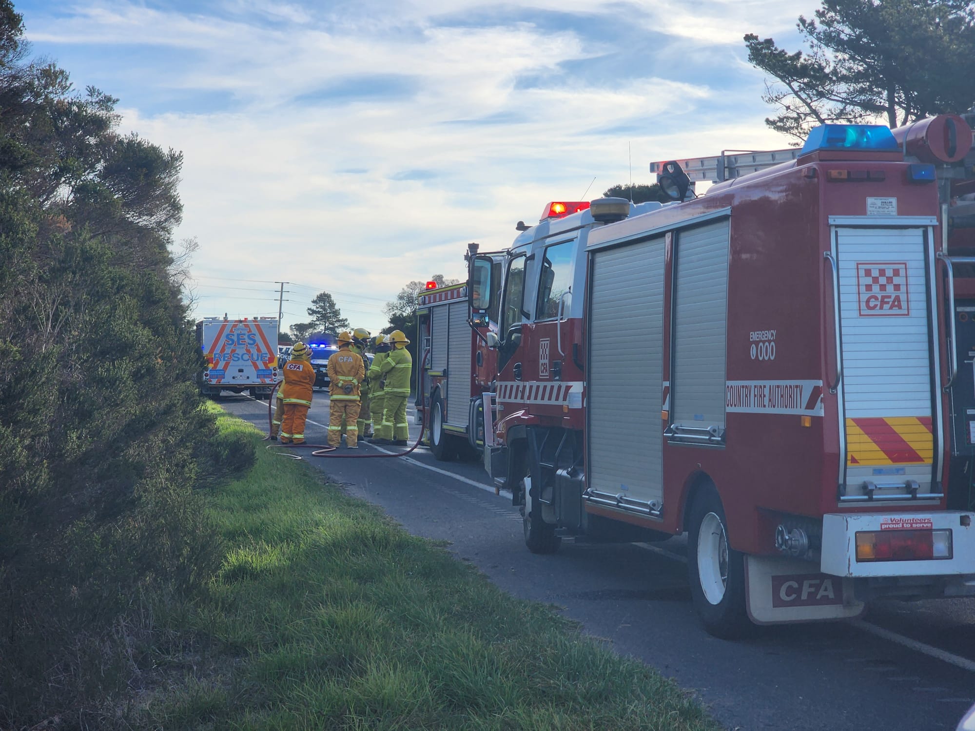 Emergency services are working to clear the scene of a two car collision on the Bass Highway this afternoon