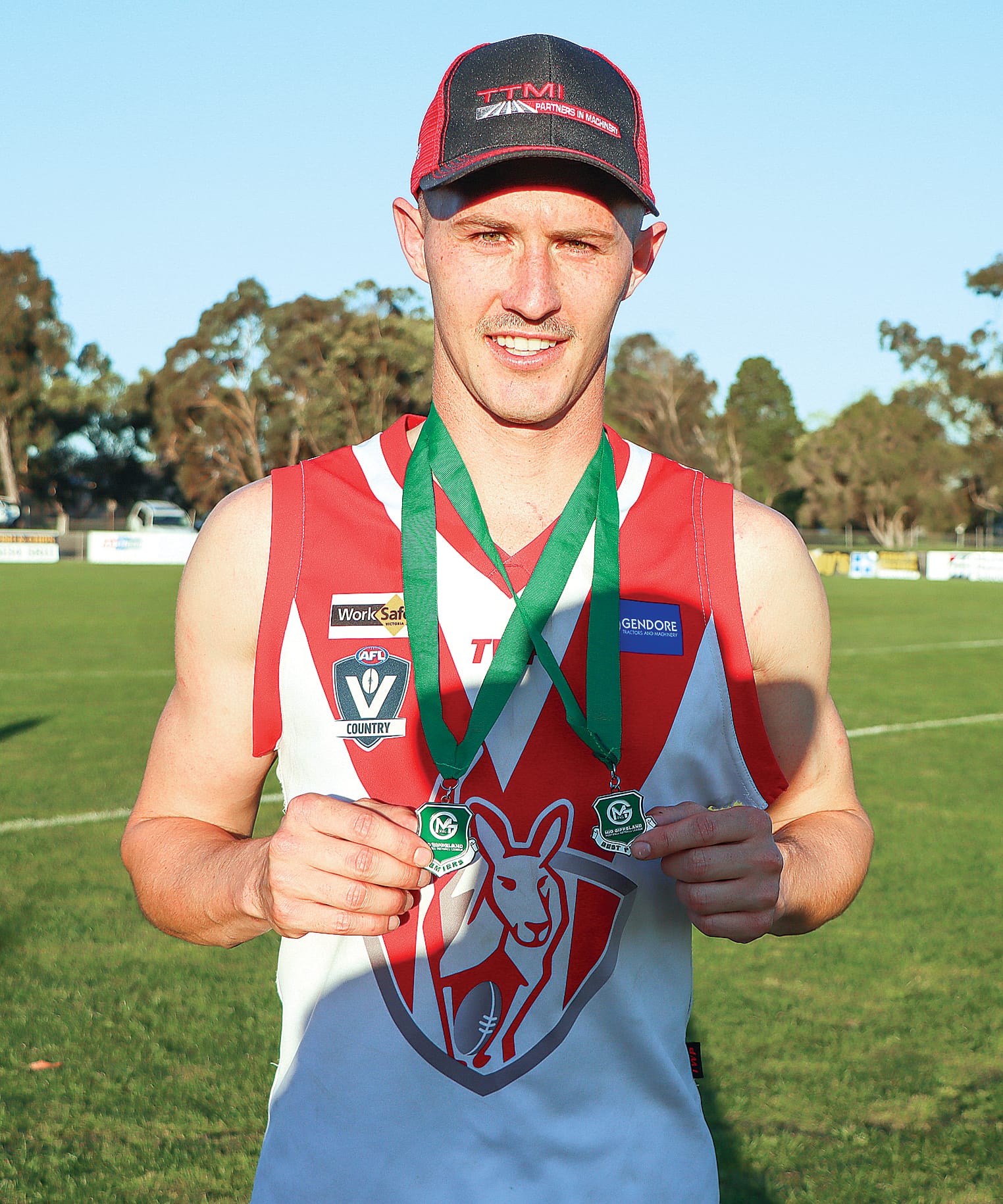 Matthew McGannon displays his premiership and best player medals after Fish Creek’s Grand Final triumph against Newborough. A41_3823