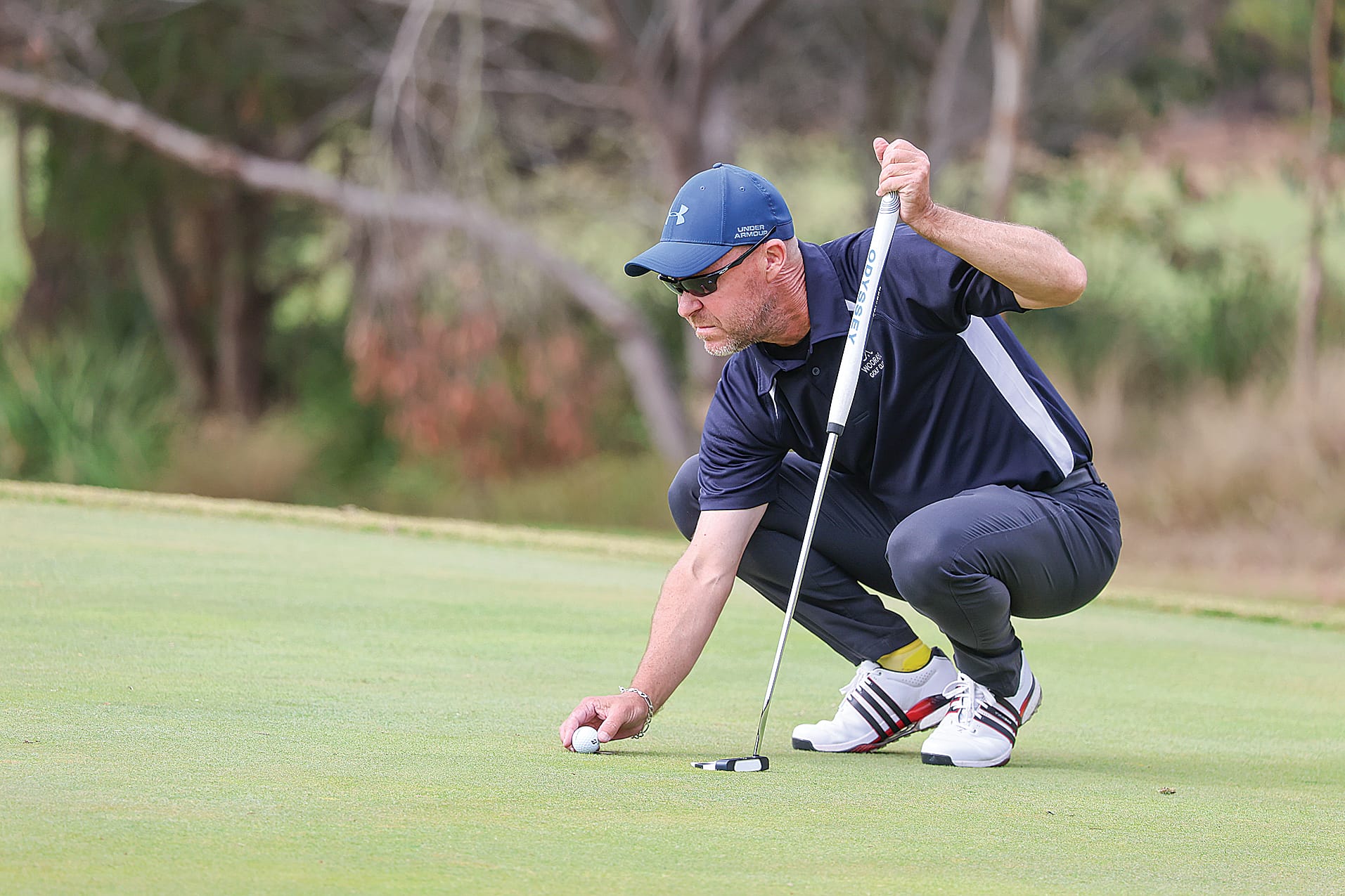 Woorayl’s Michael Thomas sizes up an important putt during an absorbing match against John Mills of Korumburra.