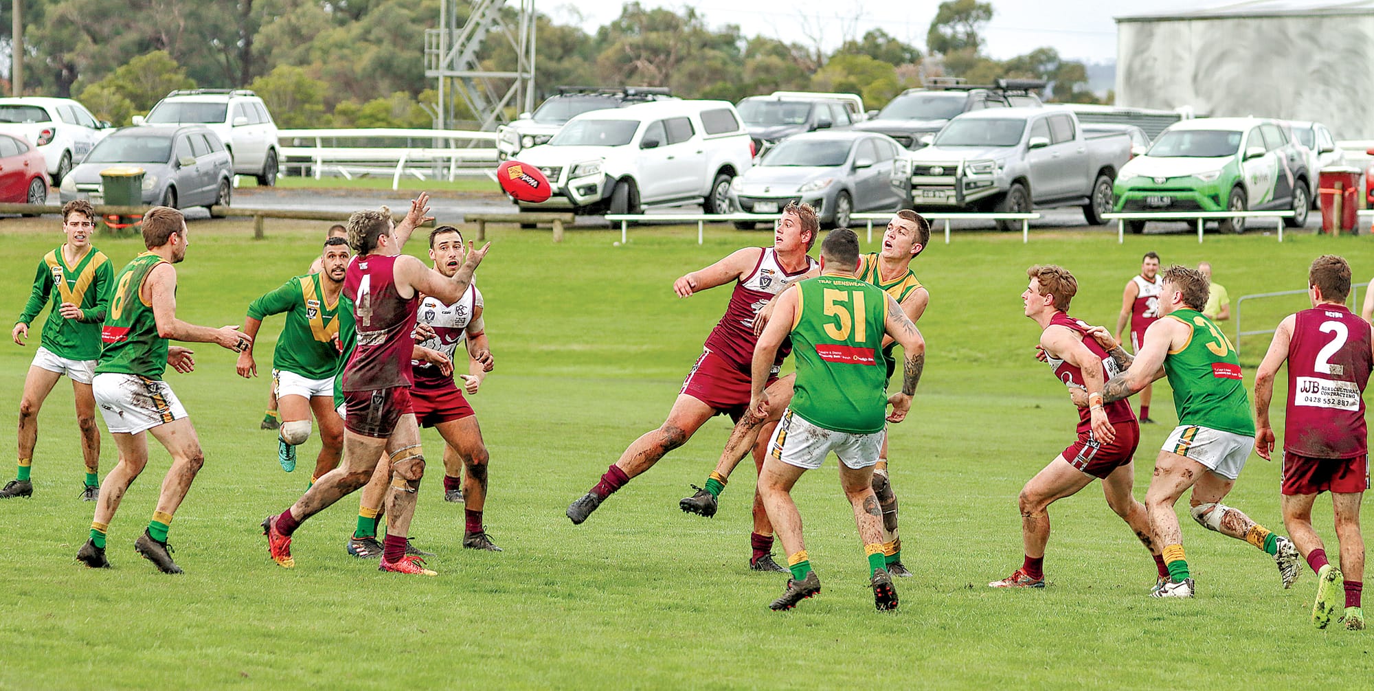Lachlan Thomas kicks under pressure from his Hill End opponent.