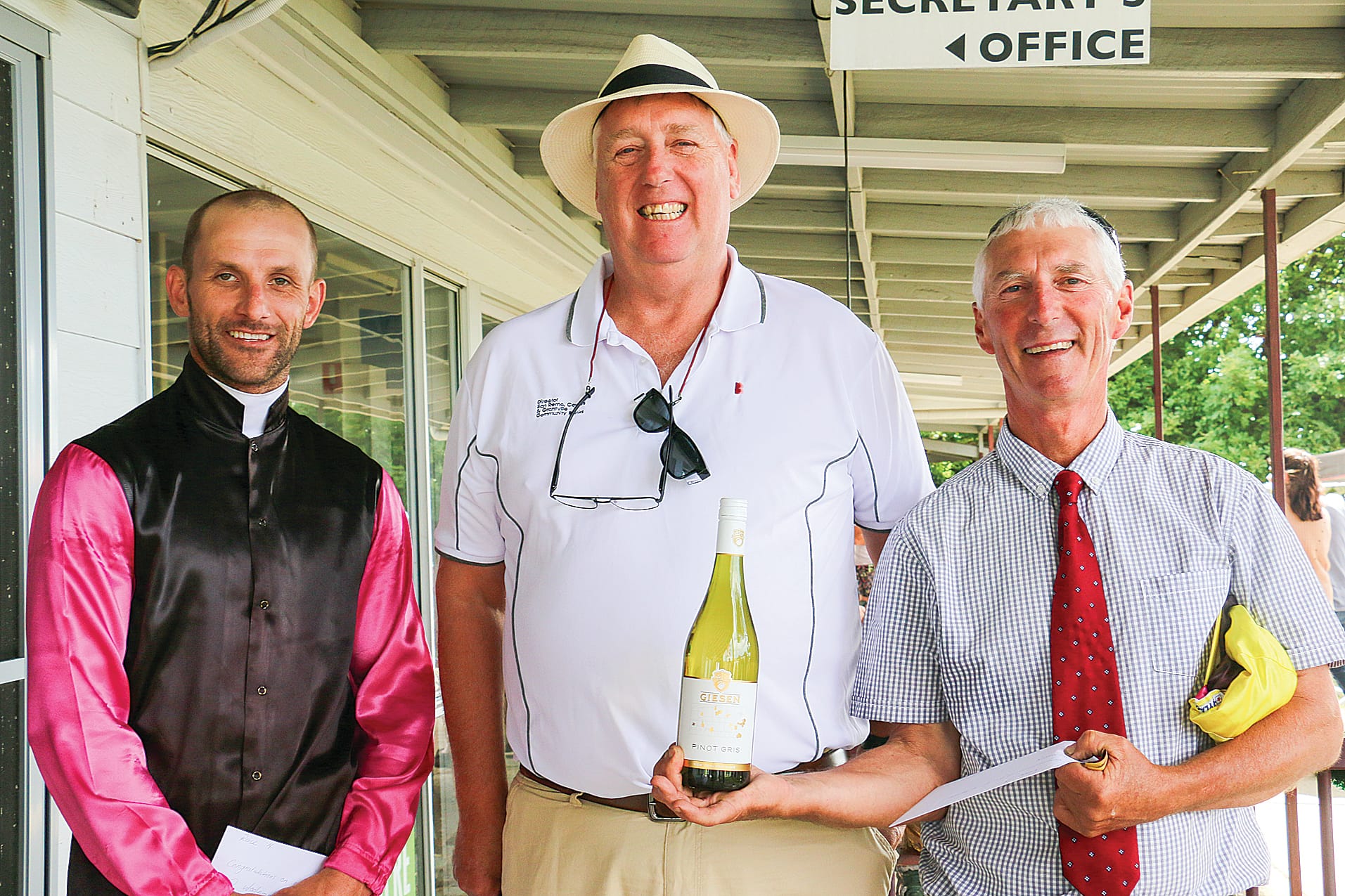 Jockey Rowan Cox, Bendigo Bank chair Kelvin Simpson and trainer Reg Manning during the presentation of the Bendigo Bank 0-28 Handicap on Saturday.
