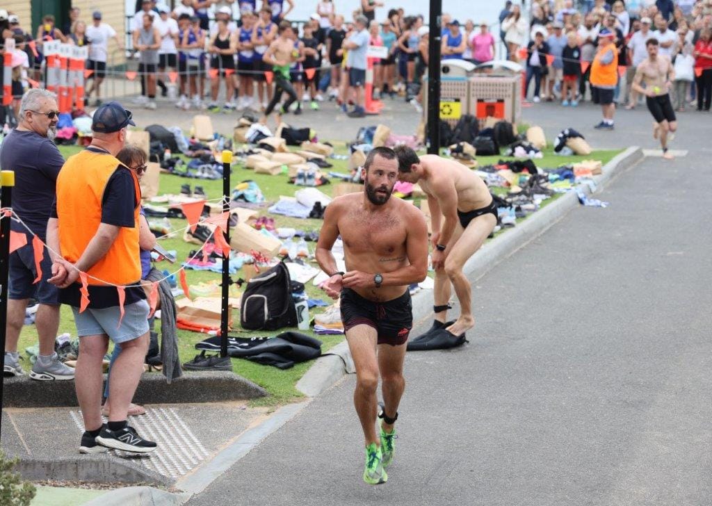 Third placegetter Phillips Tyler leaves transition on the 4km run.