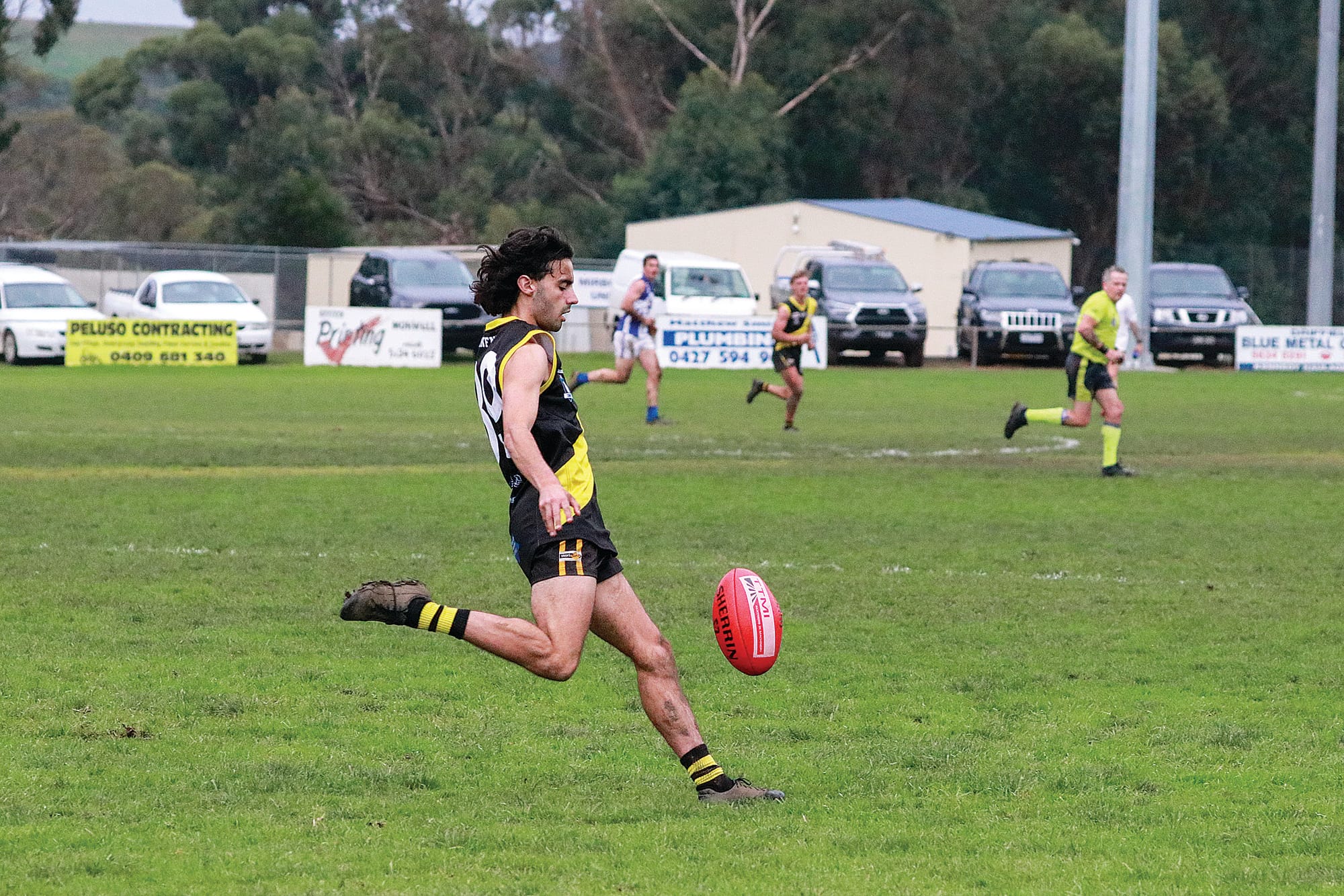 Tigers Nicholas Cummaudo kicks the ball downfield in a high pressure third quarter. Z29_2323