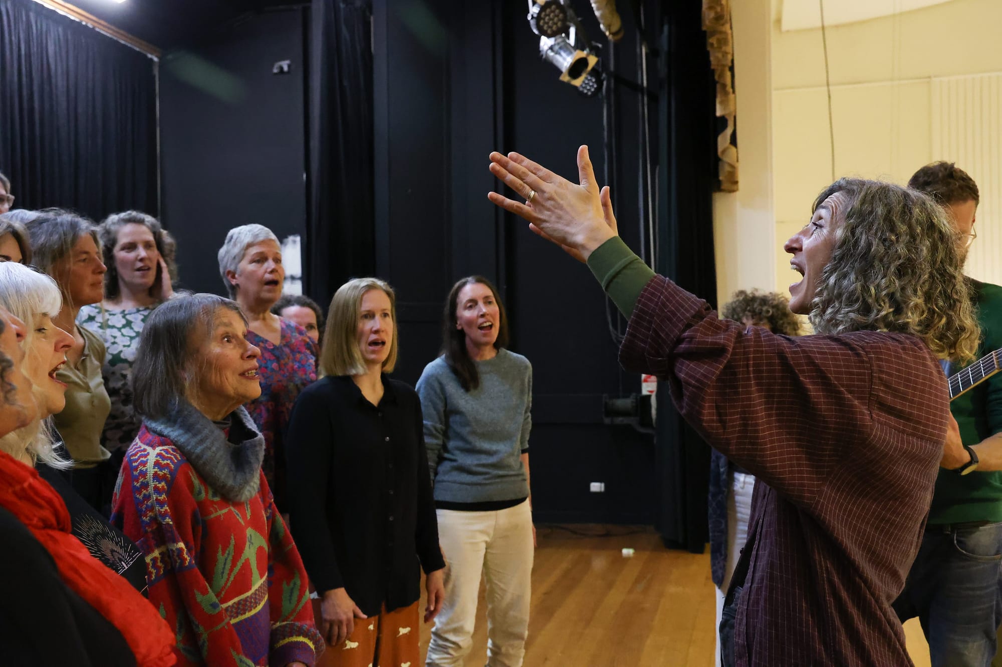 Mama Kin leads the ‘Six Week Singers’ during rehearsal.

