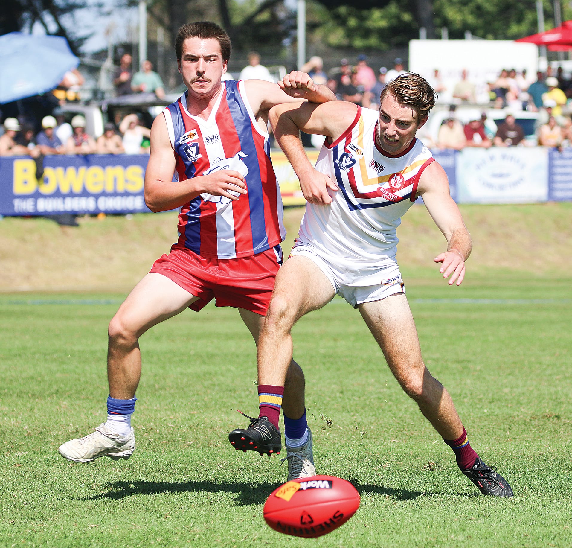 Phillip Island’s Josh Ryan battles to beat his Dusties opponent to the ball.
