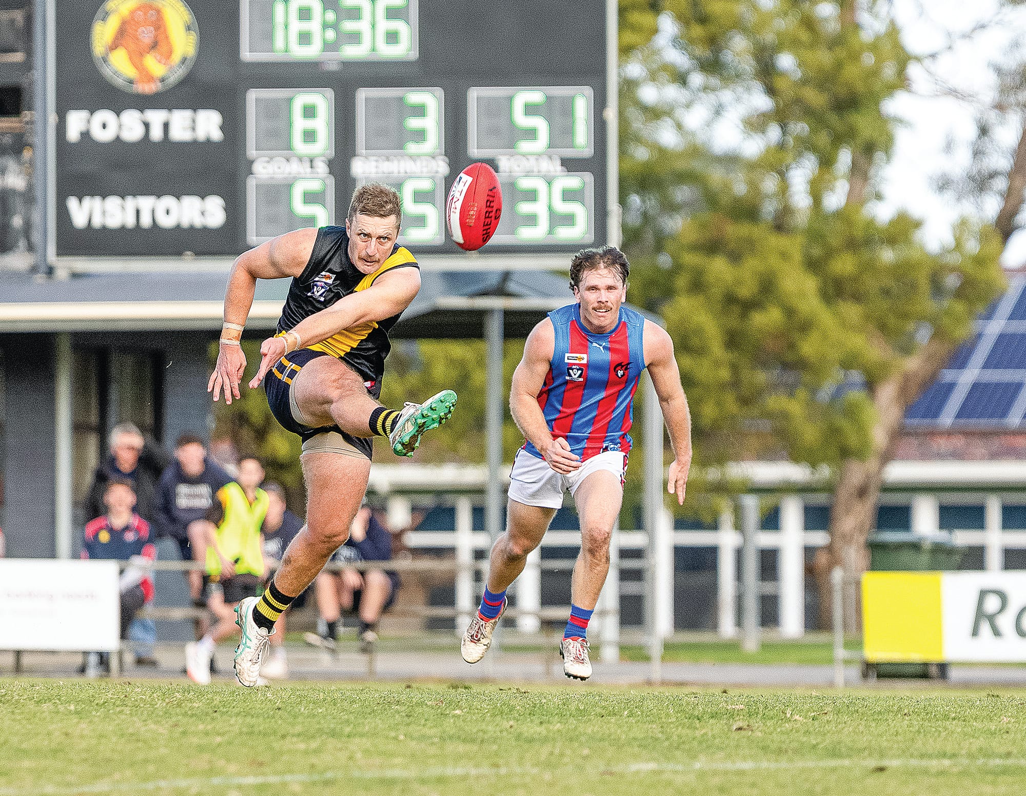 Foster’s  James Morris sinks the  boot in. Photo: Bec Casey Sports Photography.
