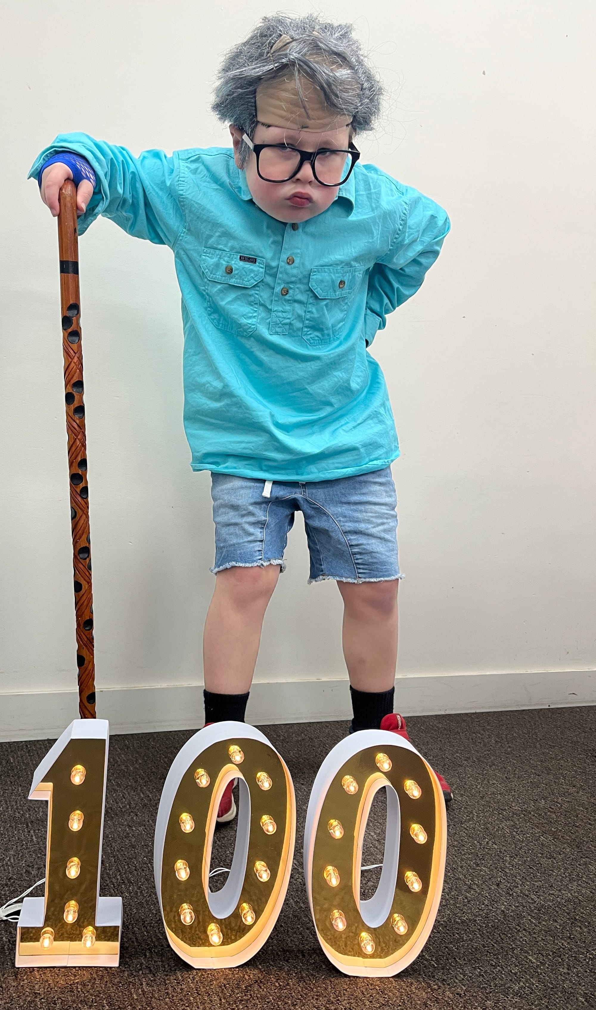 Spencer stands with the help of his walking stick.