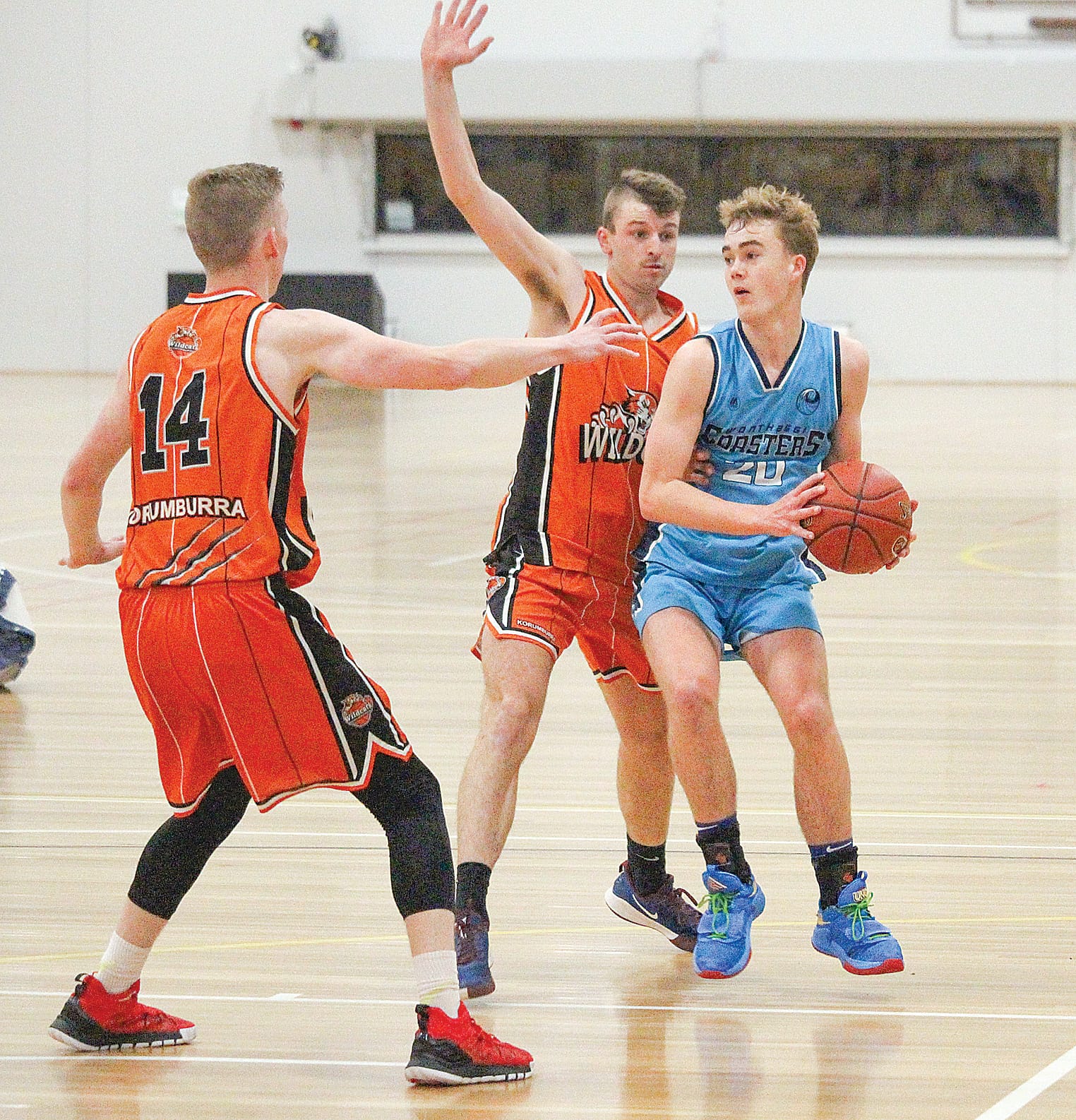 Jett Garnham looks to get the pass away as Matt Kennewell and Vincent Monaghan close in.