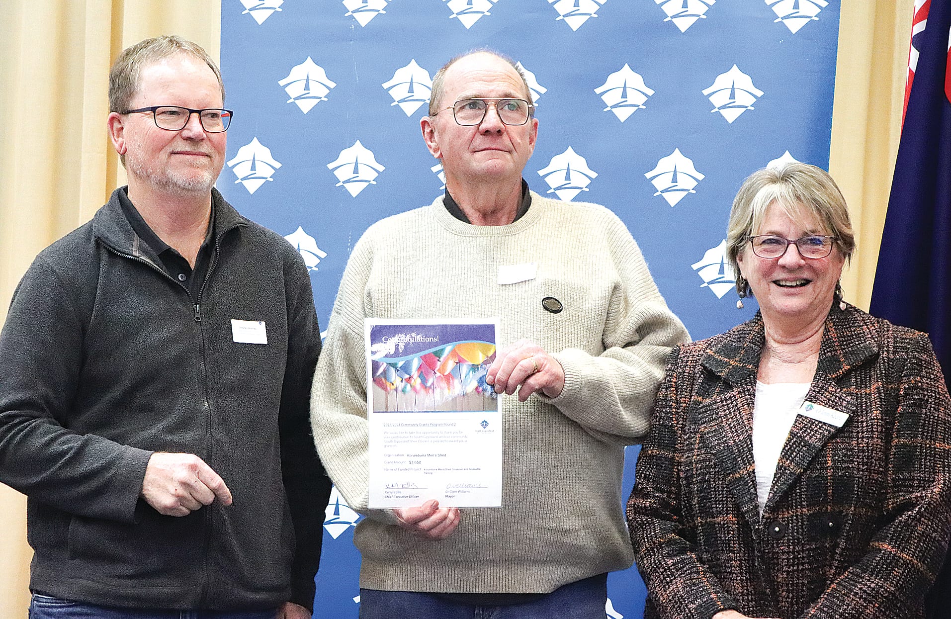 Steve Mooney and Matt Thompson of Korumburra Men’s Shed are pleased with $7650 funding to help with the cost of a crossover and accessible parking, with Cr Jenni Keerie. A07_3124