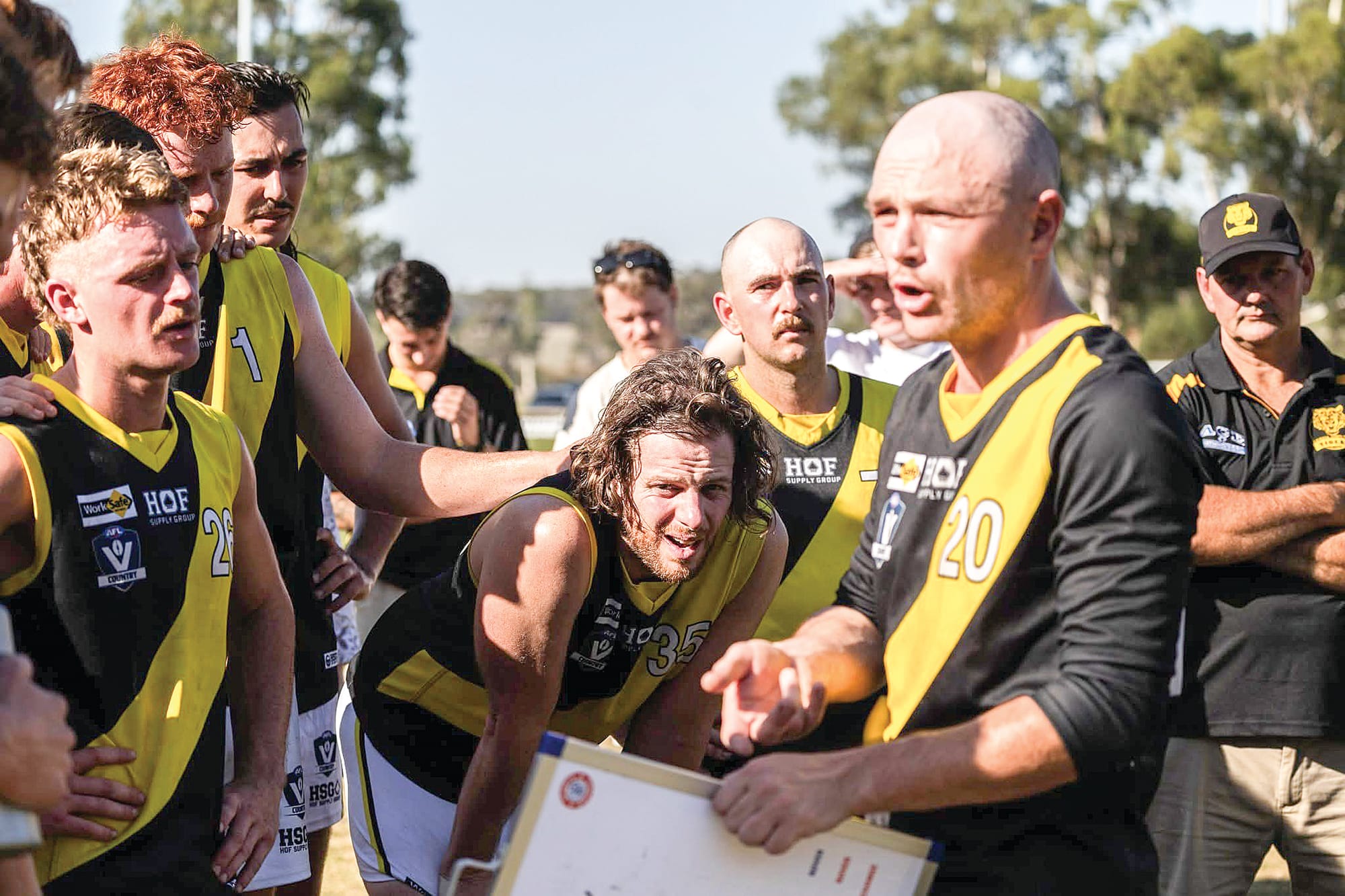 Seniors coach Damo Turner lays down the game plan for the second half. Photo: Annie Holland.