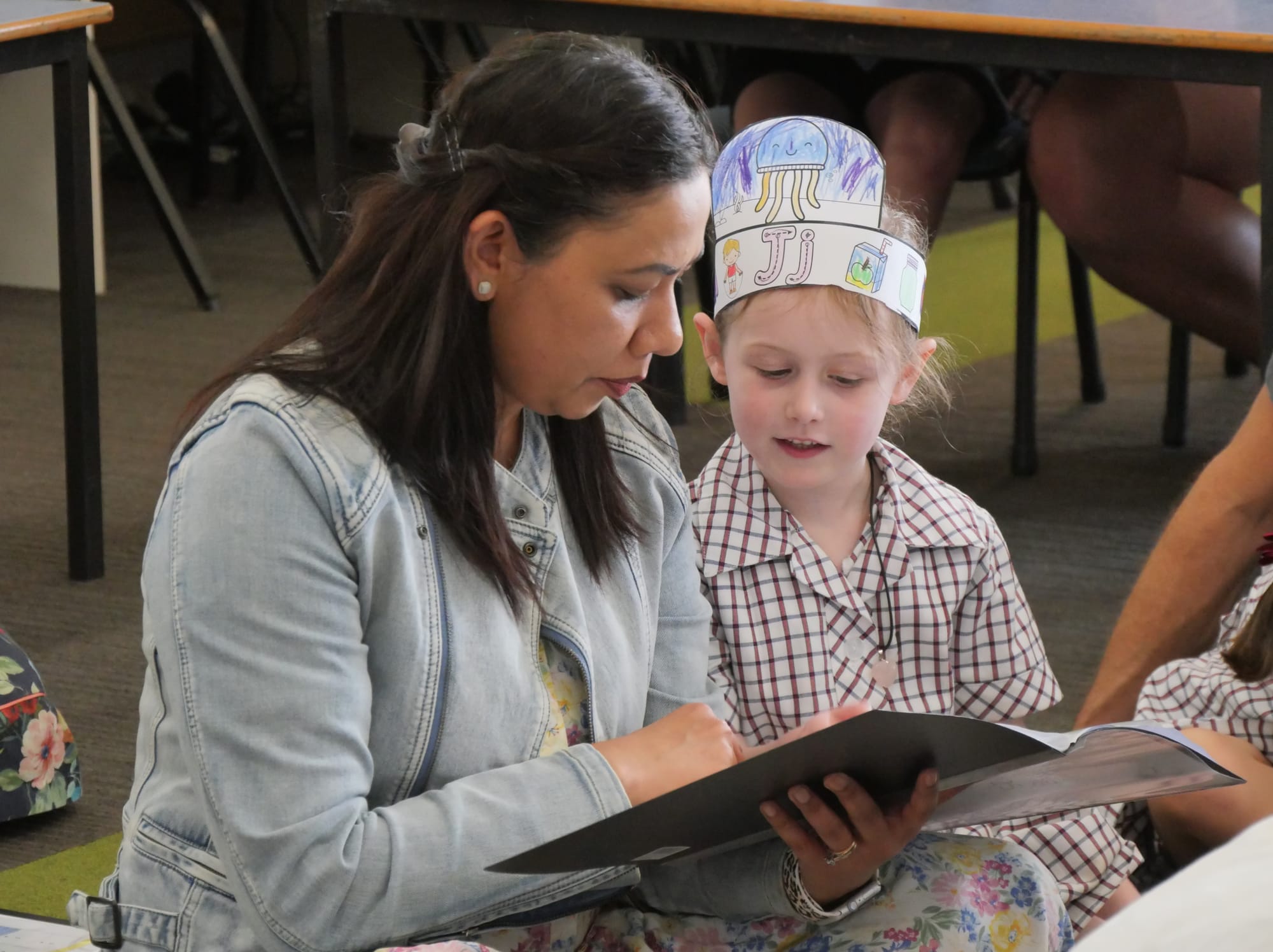 Newhaven College Prep Alison Gupta and mum Priyanka concentrate on learning about the importance of home reading to support the school curriculum.