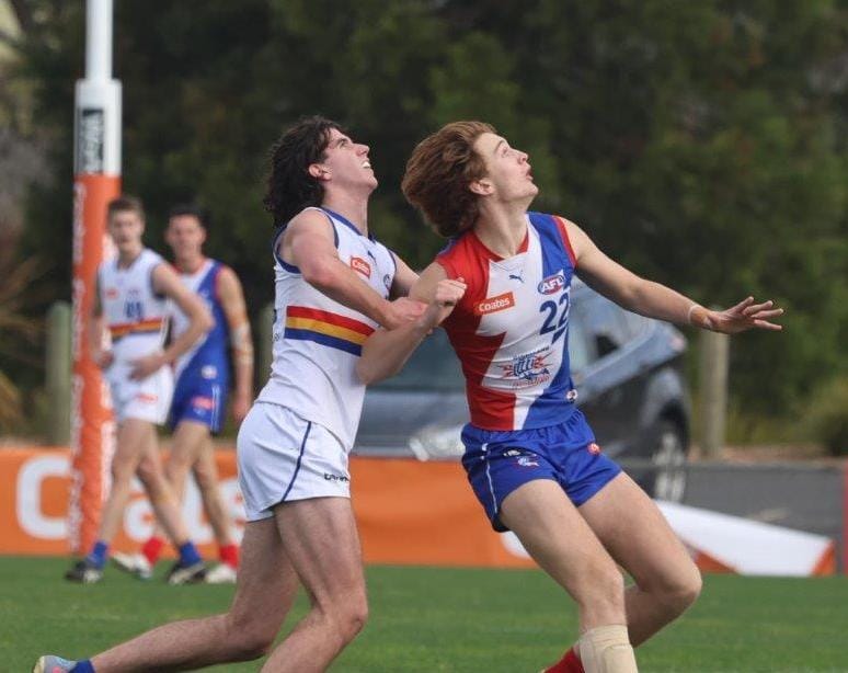 Archer Reid sets himself to mark against his Eastern Rangers opponent.