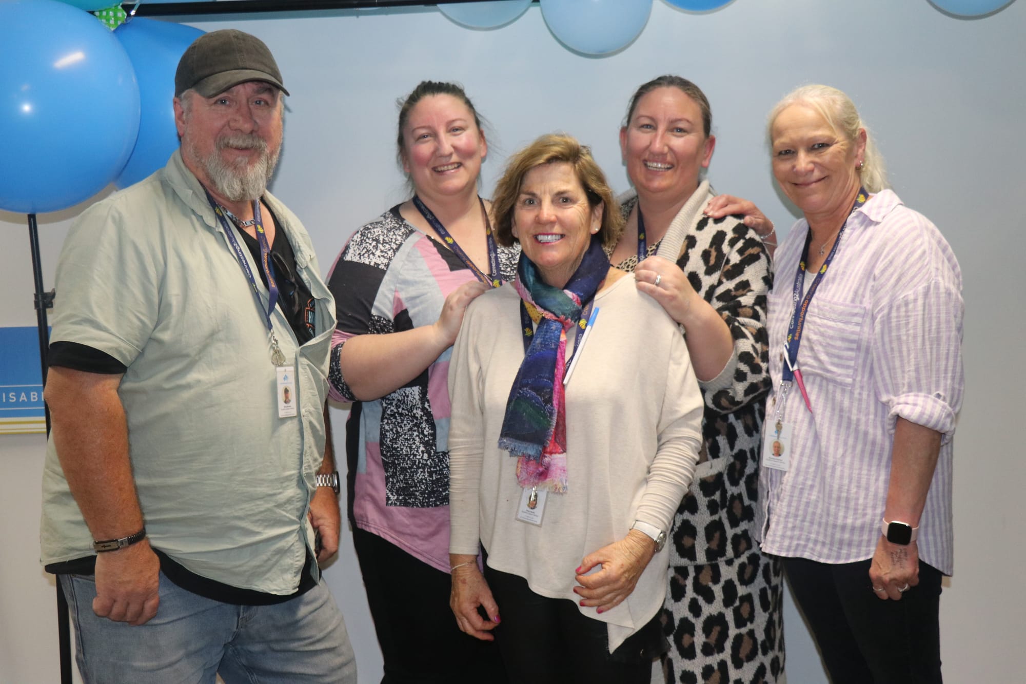 Support workers of Connecting 2 Australia Brett Gardner, Kim McLean, Patsy Hanley, Amy McAdam, and Bronwyn Pearson gather for the 70th anniversary of disability support. 