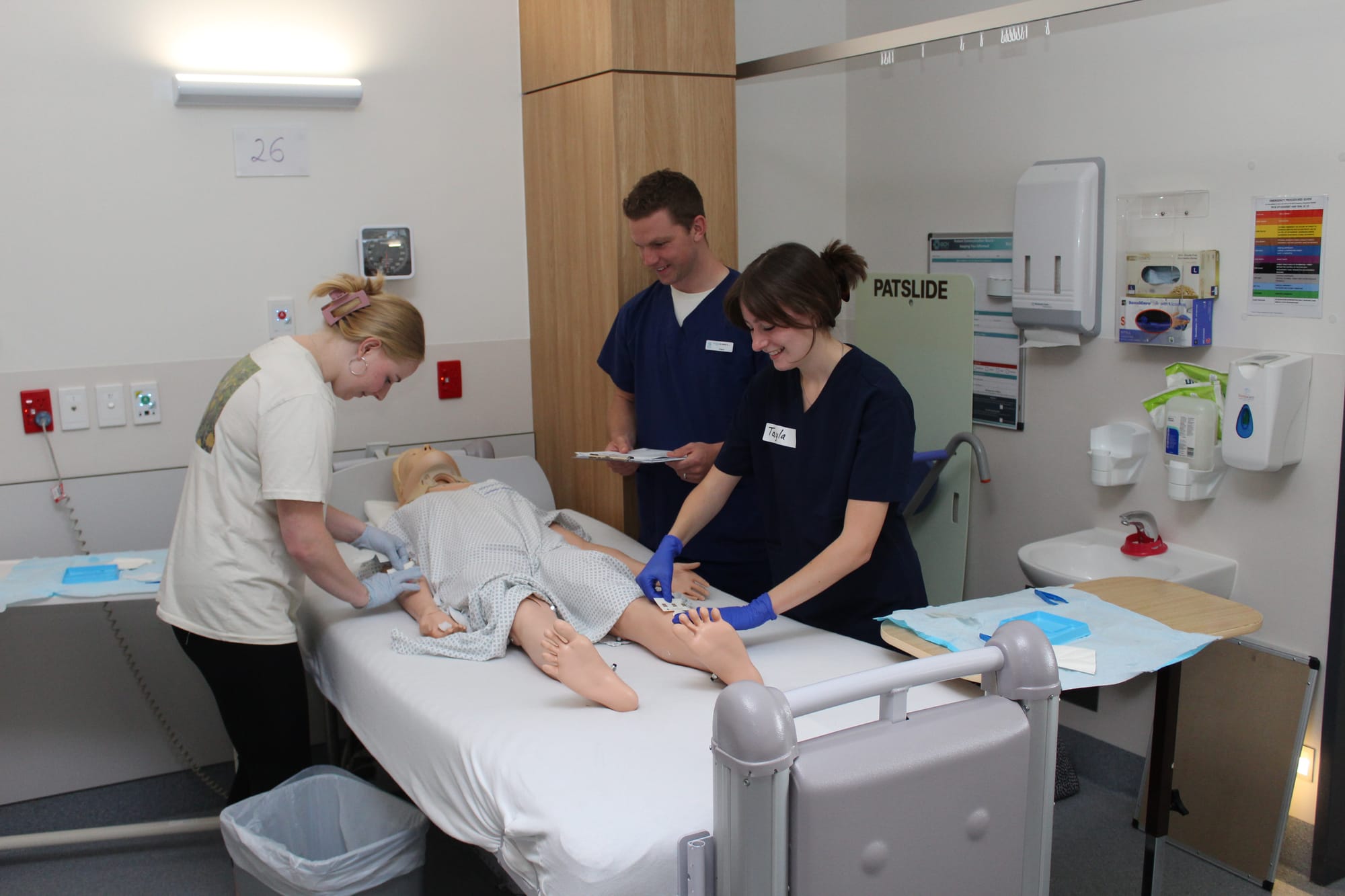 Clinical Development Nurse Liam Kennedy trains Registered Students of Undergraduate Nursing Hayley Geary and Tayla Fixter.