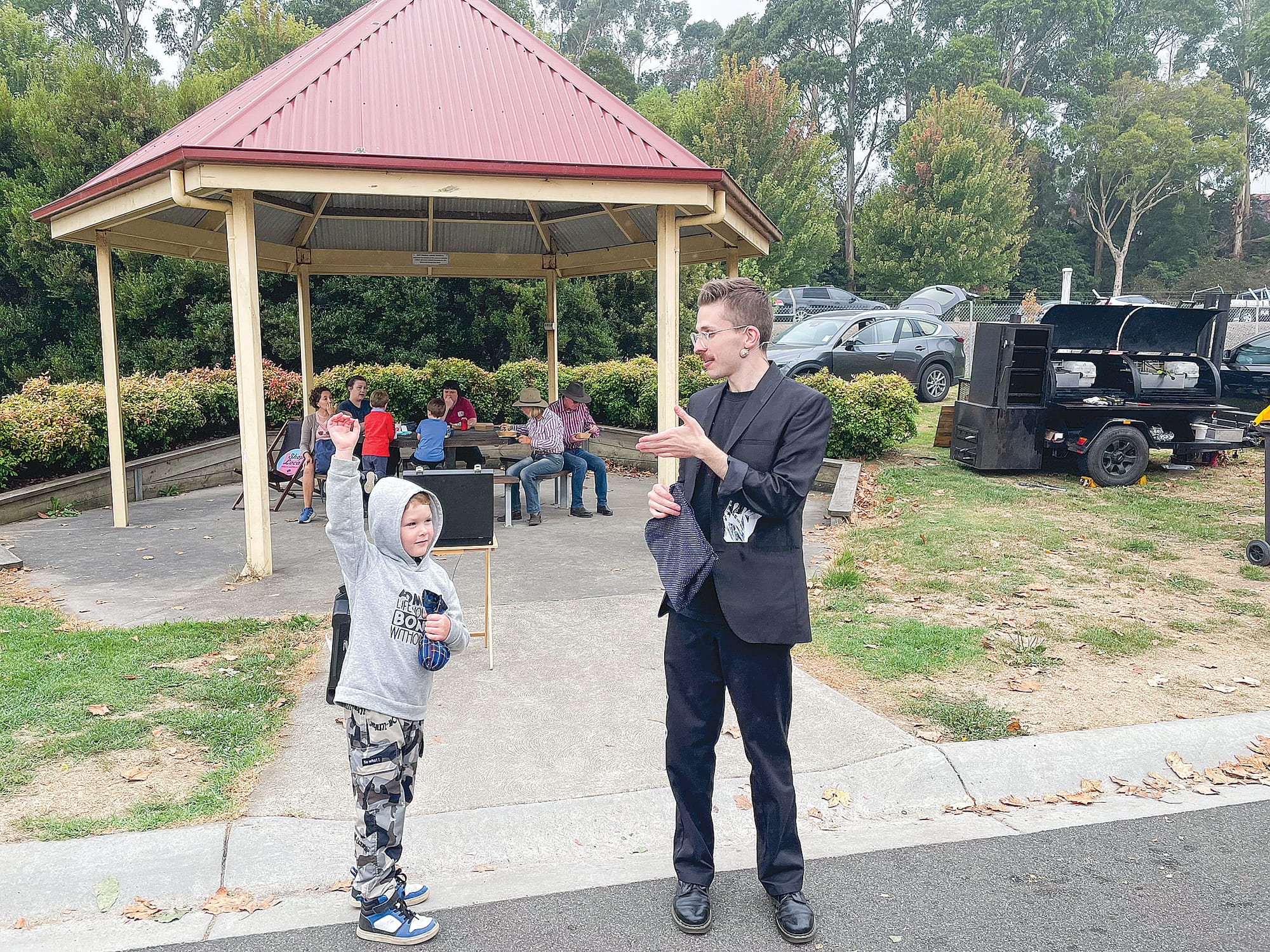 Local Jackson Rogers keeps an eye on magician Lachlan Wilde, expressing confidence his trick will succeed. A41_0625