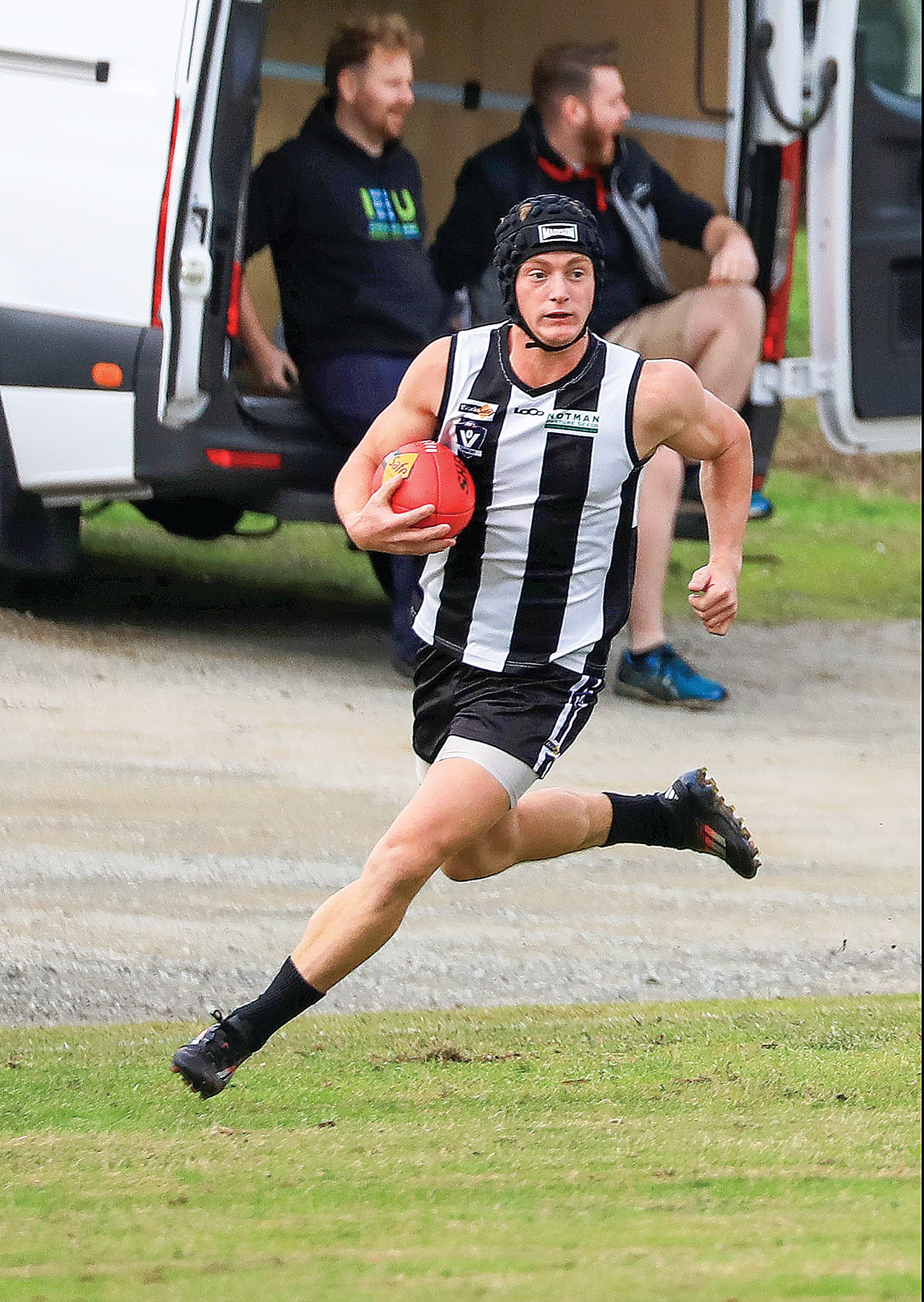 Poowong’s Mitch Molloy tucks the  ball under his arm and takes off on a run in the tight senior contest. Photo: Jeff Tull
