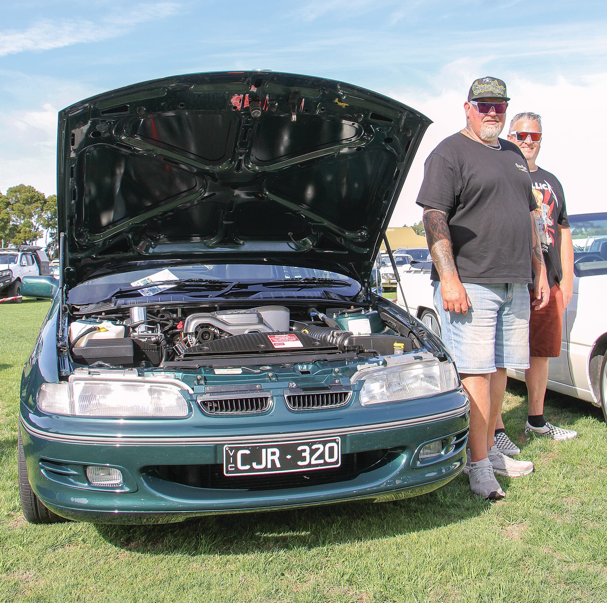 Greg from Dalyston with a fellow commodore enthusiast at the Korumburra showgrounds. B148_0225