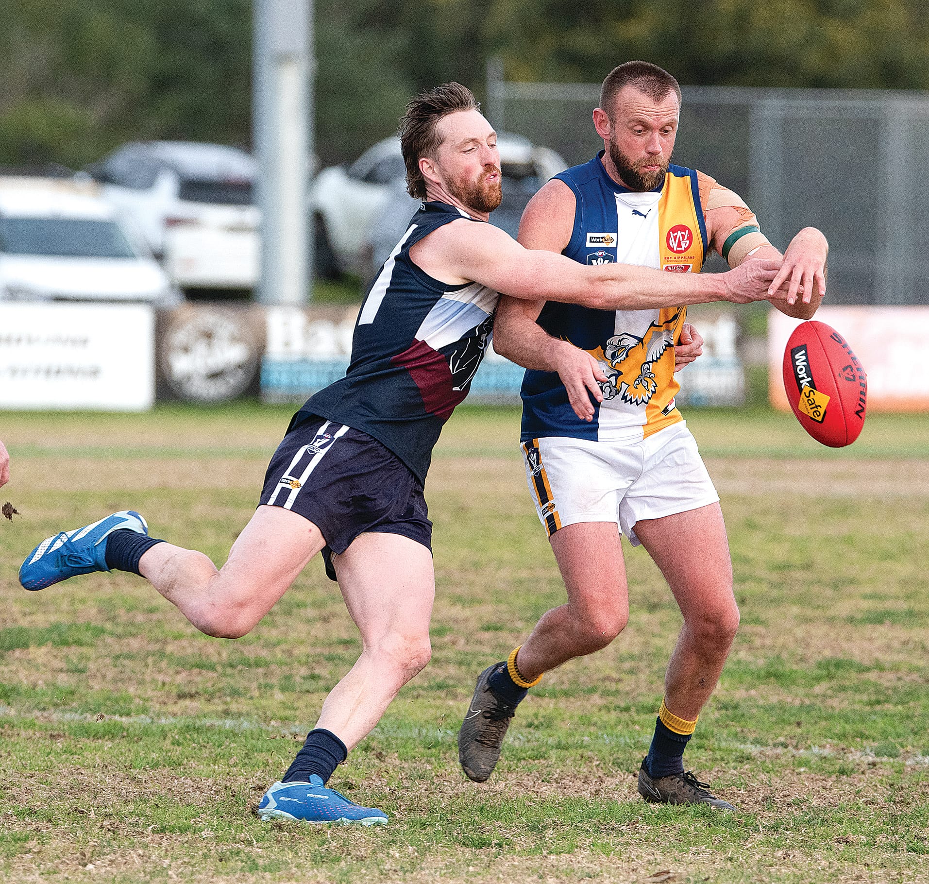 Tom Hams attempts to put boot to ball before being run down by Jack Soroczynski. Photos: Anna Carson