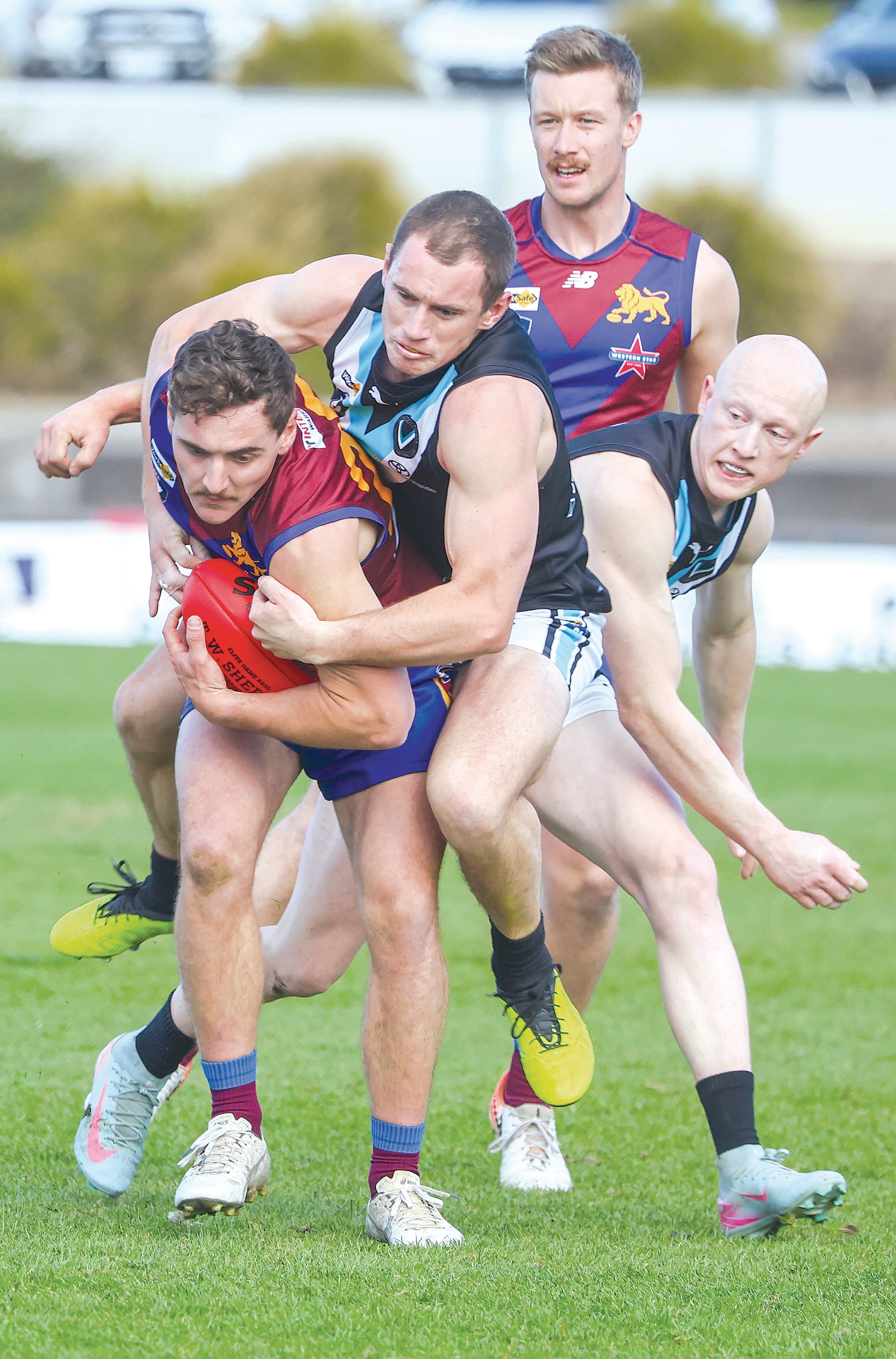Ride’em cowboy! Wonthaggi’s Kaj Patterson tries to stop Moe’s Alex Dijkstra breaking away from the stoppage with Jye Gilmour in support.