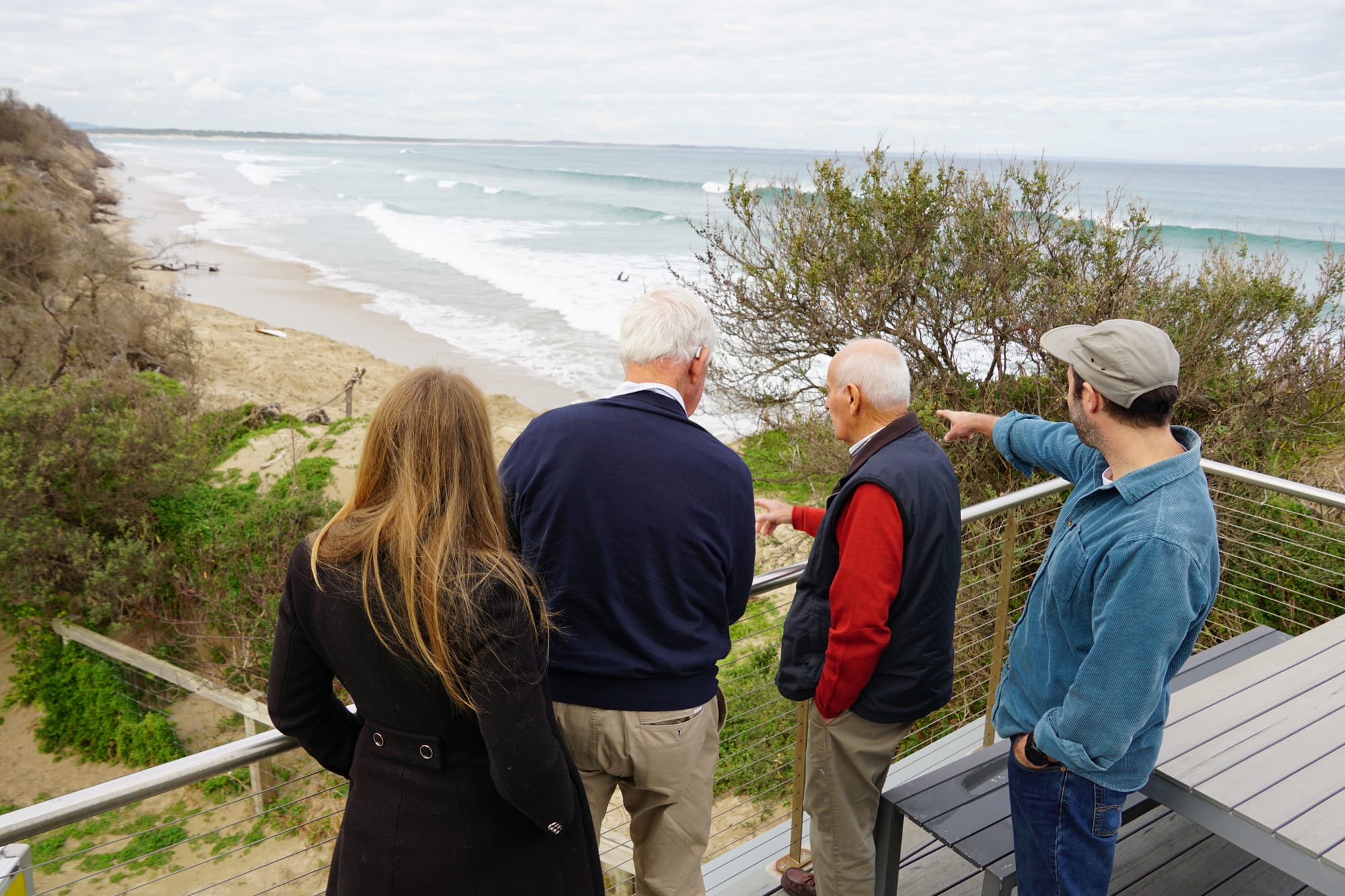 Inverloch Foreshore Action Group committee members overlook the erosion from the lifesaving club.