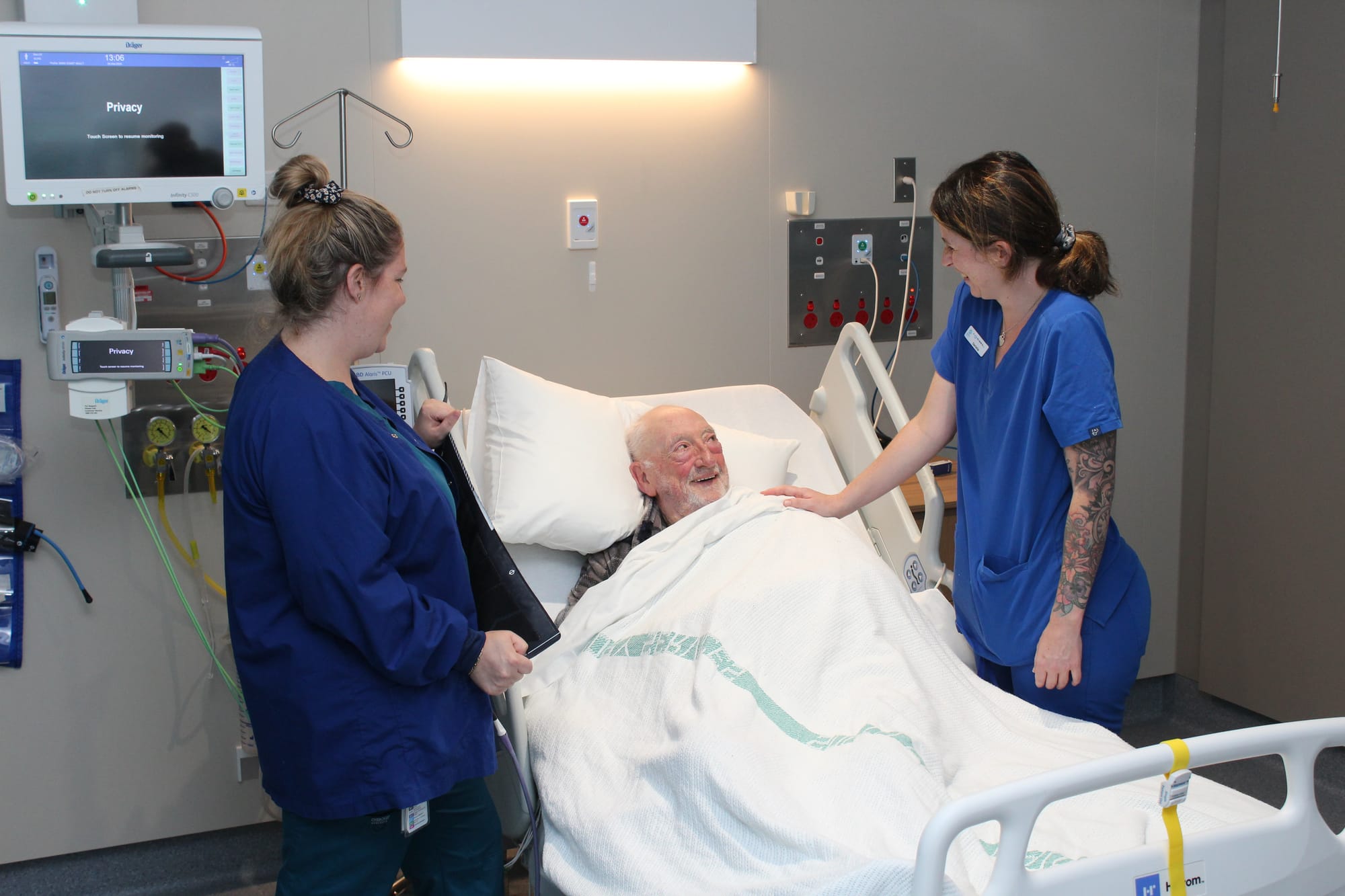 Registered Nurses Janessa McLean, left, and Danielle Peters care for patient Gary Lyon on Kodowlinun Ward at Wonthaggi Hospital.