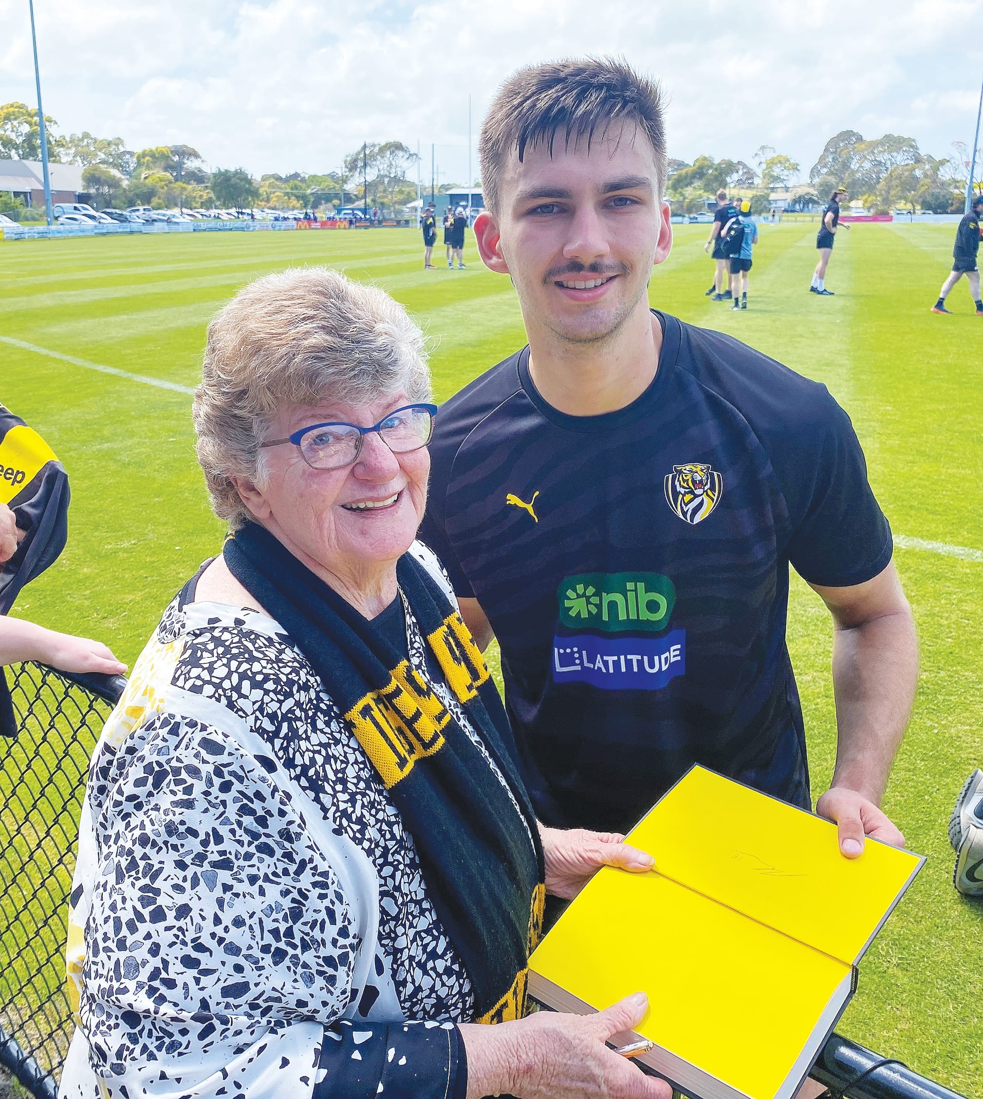 Libby Carr of Wonthaggi gets her book signed by rising star Josh Gibcus during a training run at Wonthaggi.