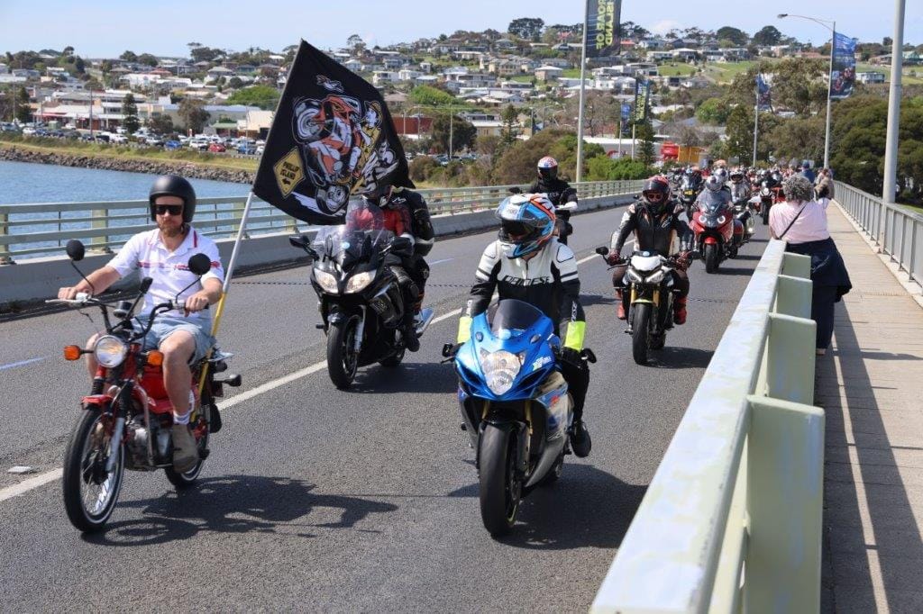 Riding a postie bike for the San Remo Bridge crossing, this rider display his support for Aussie hope Jack Miller.