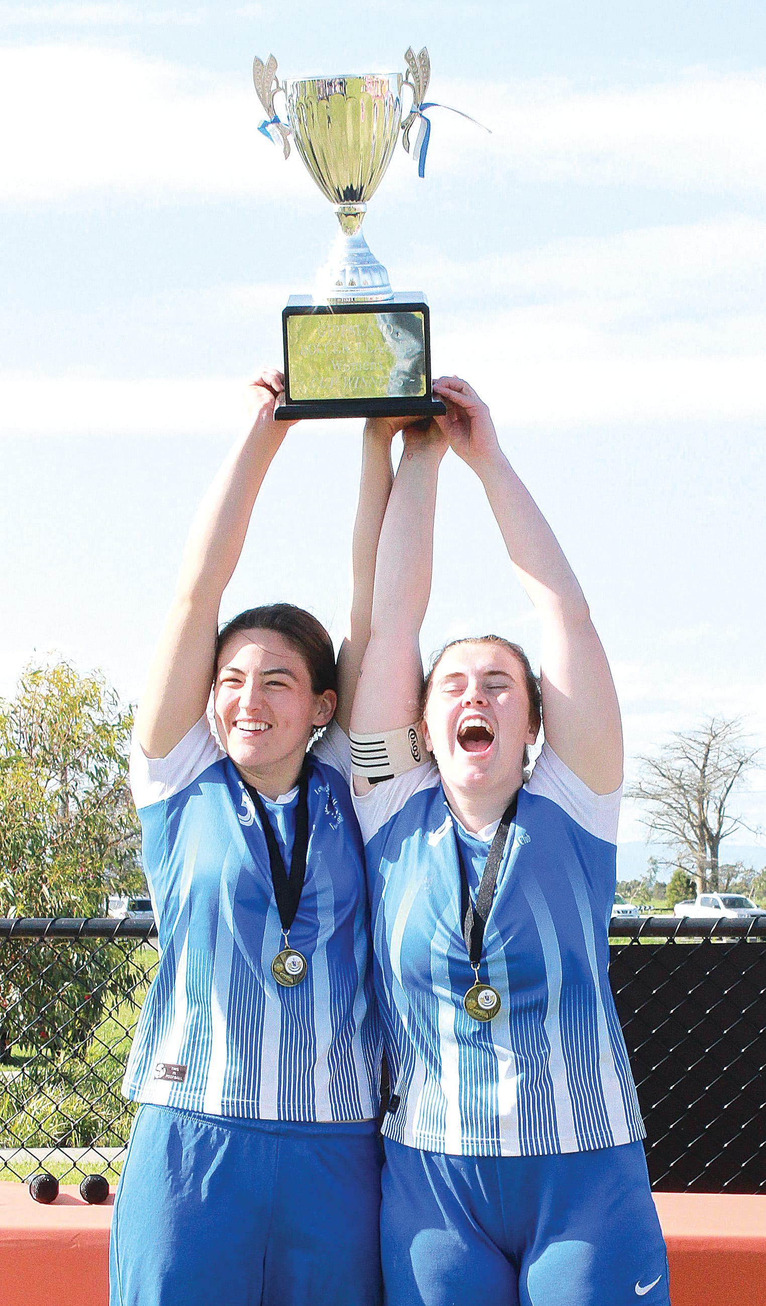 Leongatha co-captains Melisse Bath and Jasmine Garry celebrate their premiership win.