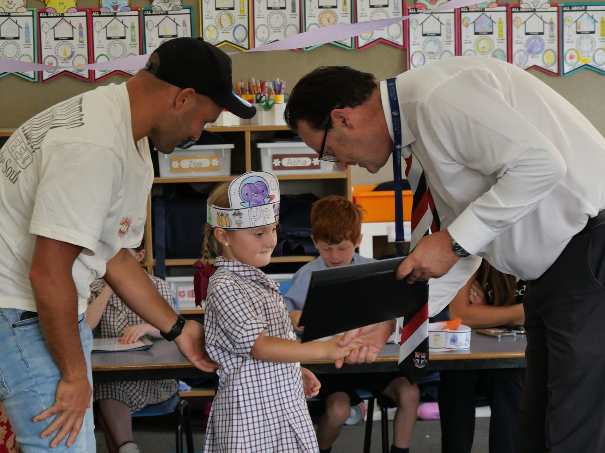 Newhaven Prep Sunny Jose was presented with her reading folder and congratulated by Principal Tony Corr, while proud dad Jai watched on.