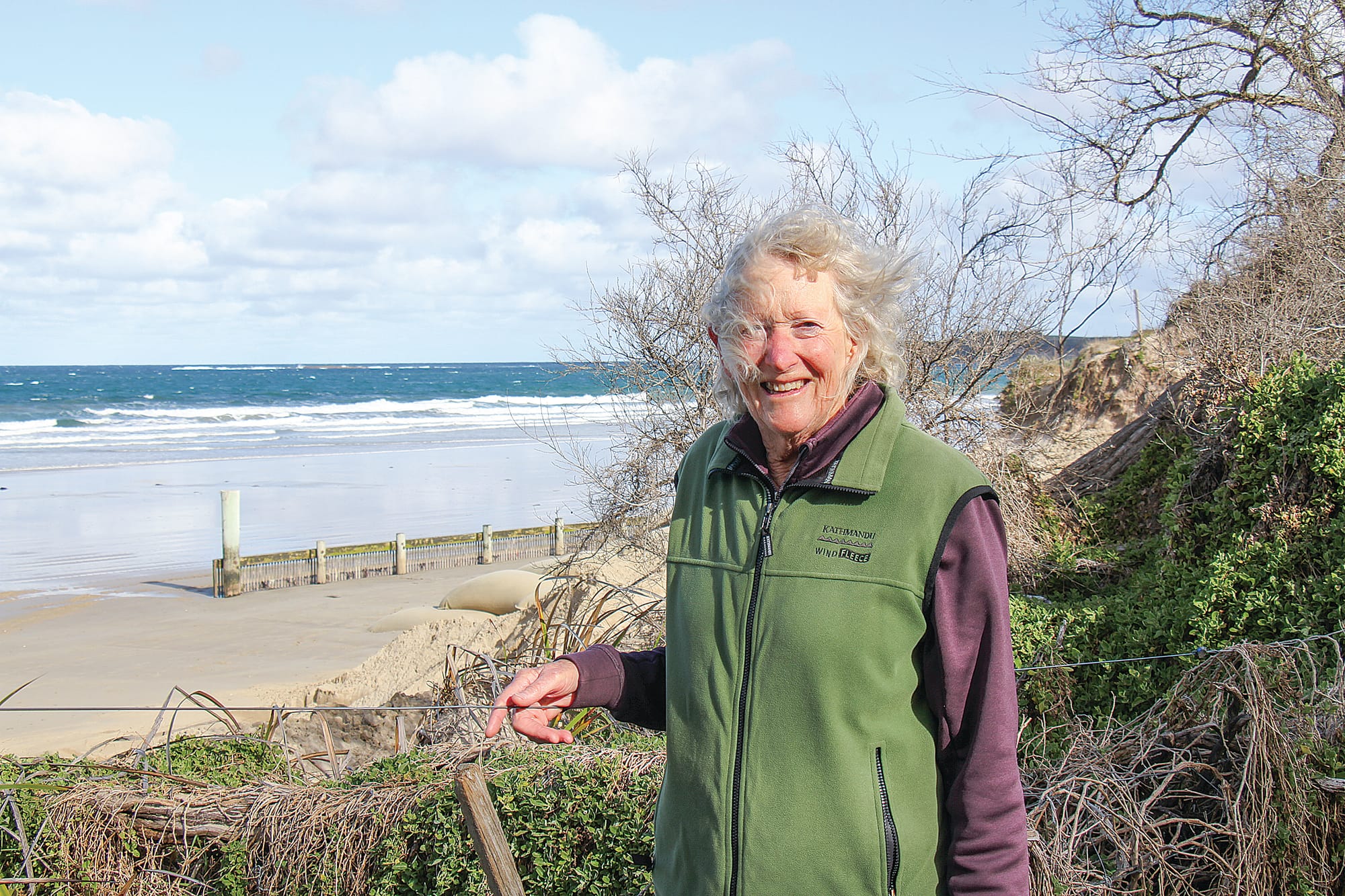 Lohr Avenue resident Jo Innes watching sand being replaced at the Inverloch SLSC after a recent storm surge and high tides. B15_2325
